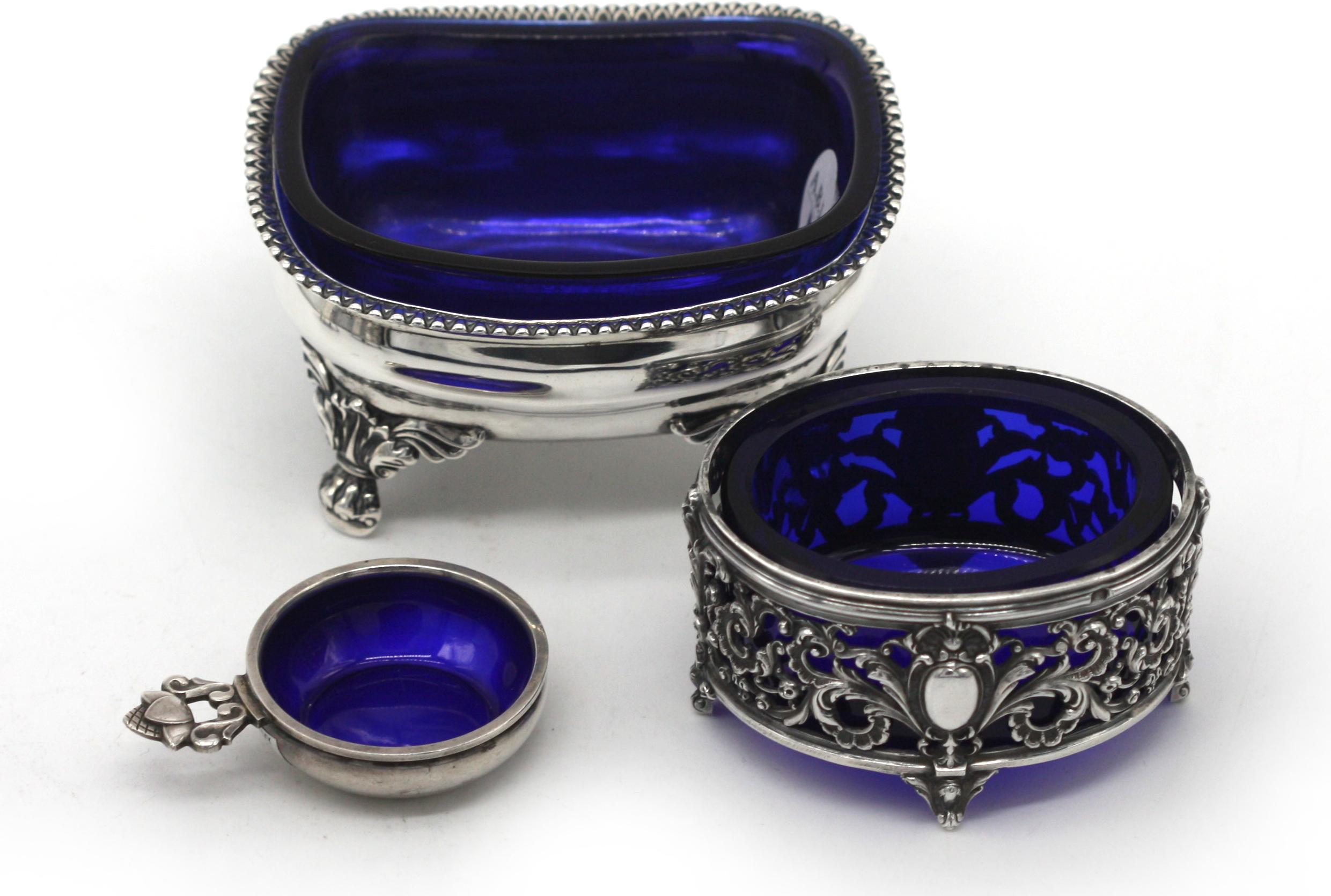 
Five Various Silver and Cobalt Glass Salts.
Comprising, a George III pair, maker William Abdy, of navette form with neoclassical motifs and claw-and-ball feet, another George III example, probably Solomon Hougham, an Continental example, oval and