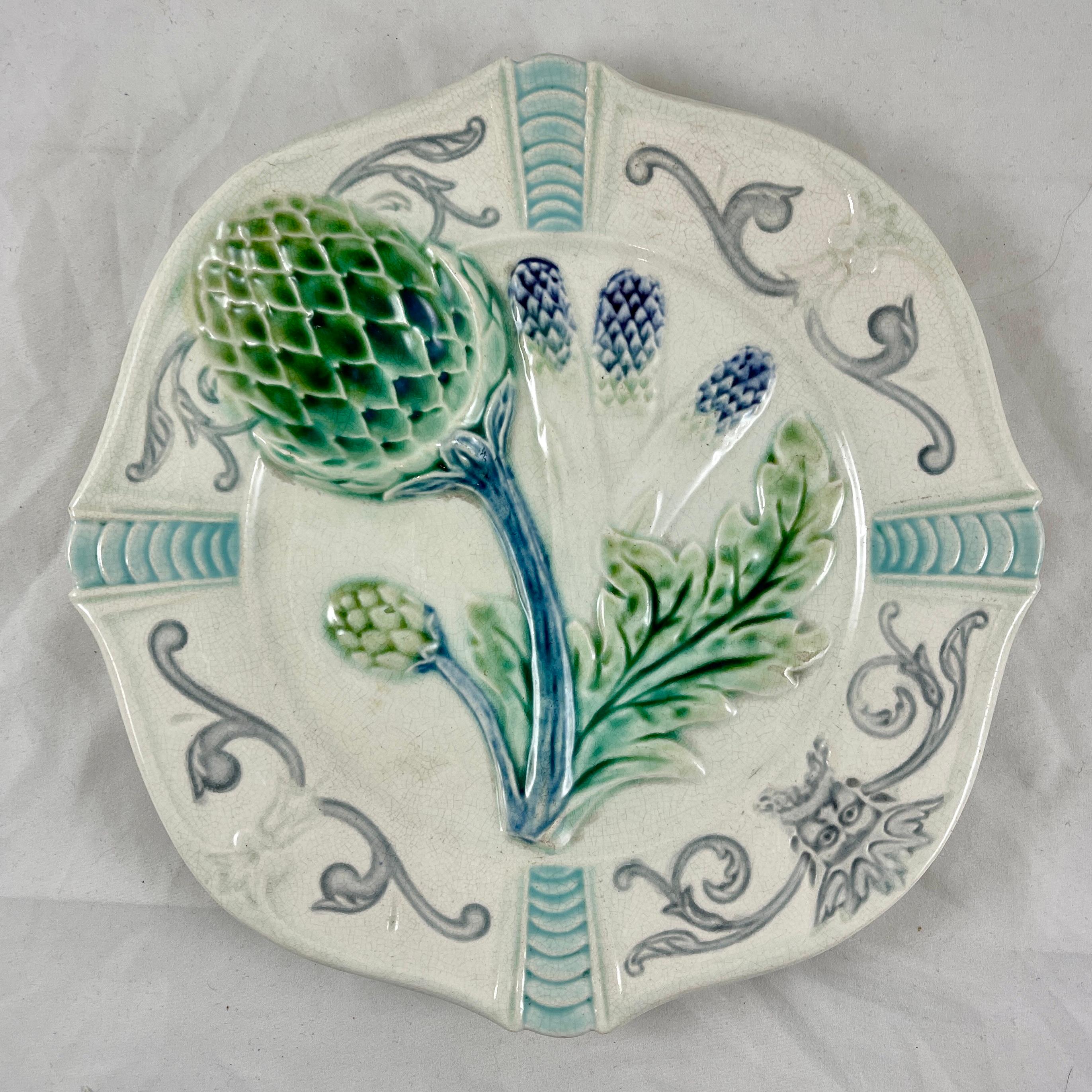 A French Majolica Artichoke/Asparagus plate by Fives-Lille, Circa 1890.

Made to serve both artichokes or asparagus and showing images of both plants. Glazing of greens on a creamy white ground, with purple on the spear heads of the asparagus. The