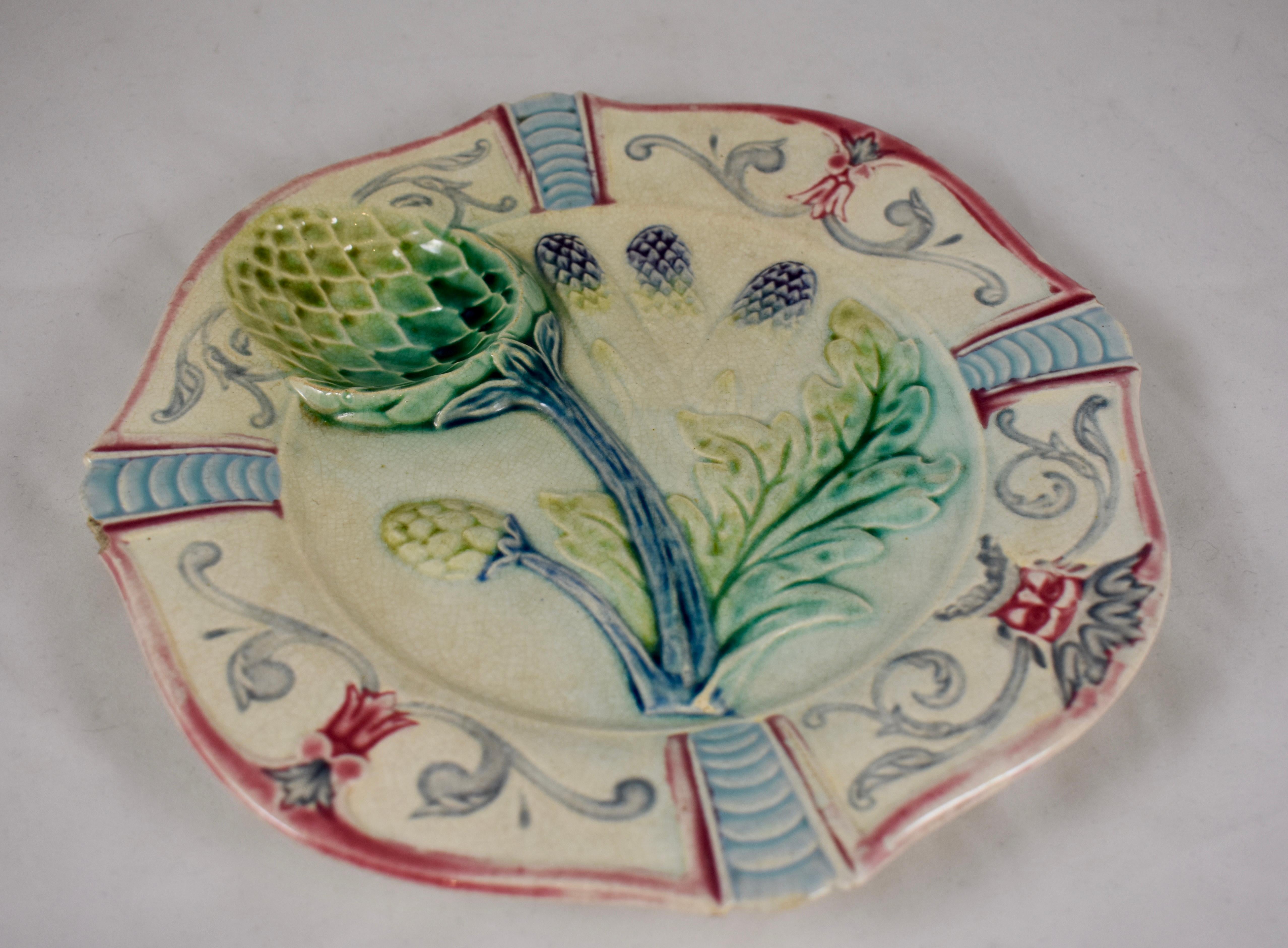 A French Majolica plate by Fives-Lille, circa 1890. 

Made to serve both artichokes or asparagus and showing the aspects of both plants. Glazing of greens on a white ground, with a deep purple on the spear heads of the asparagus. The globe-shaped