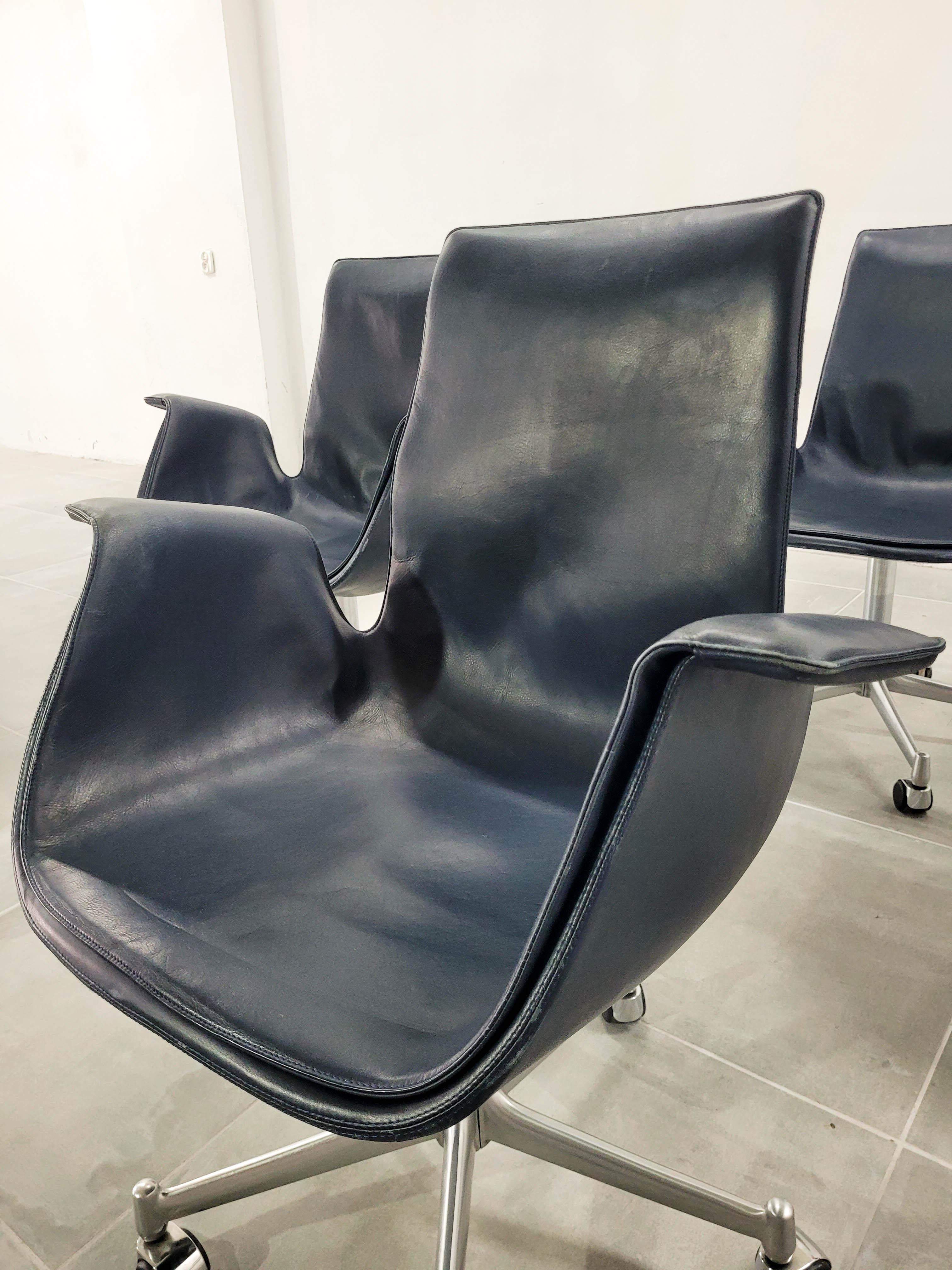 Astonishing set of 4 comfortable office chairs. No height adjustment. Navy blue leather. 
