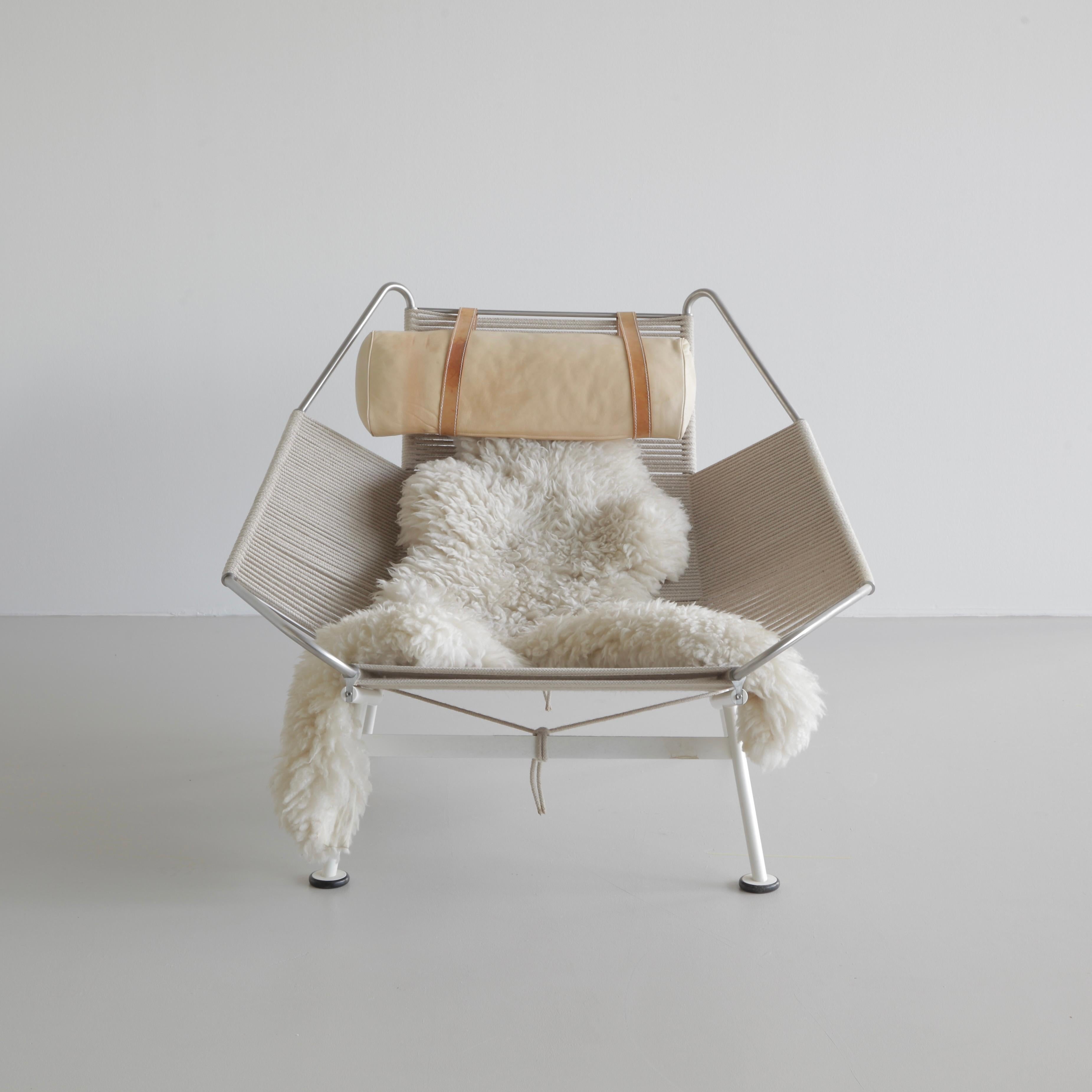 Vintage lounge chair designed by Hans J. Wegner. Denmark, PP Mobler, 1950.

The PP225 lounge chair, white stainless steel frame with one single natural halyard flag covered with a longhaired sheepskin. The flag line is made of natural linen woven
