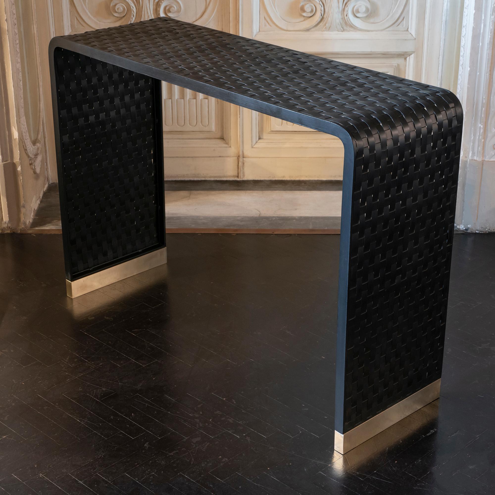 “Intreccio” console part of the Flair Edition Collection realized in black painted natural steel with natural brass details.