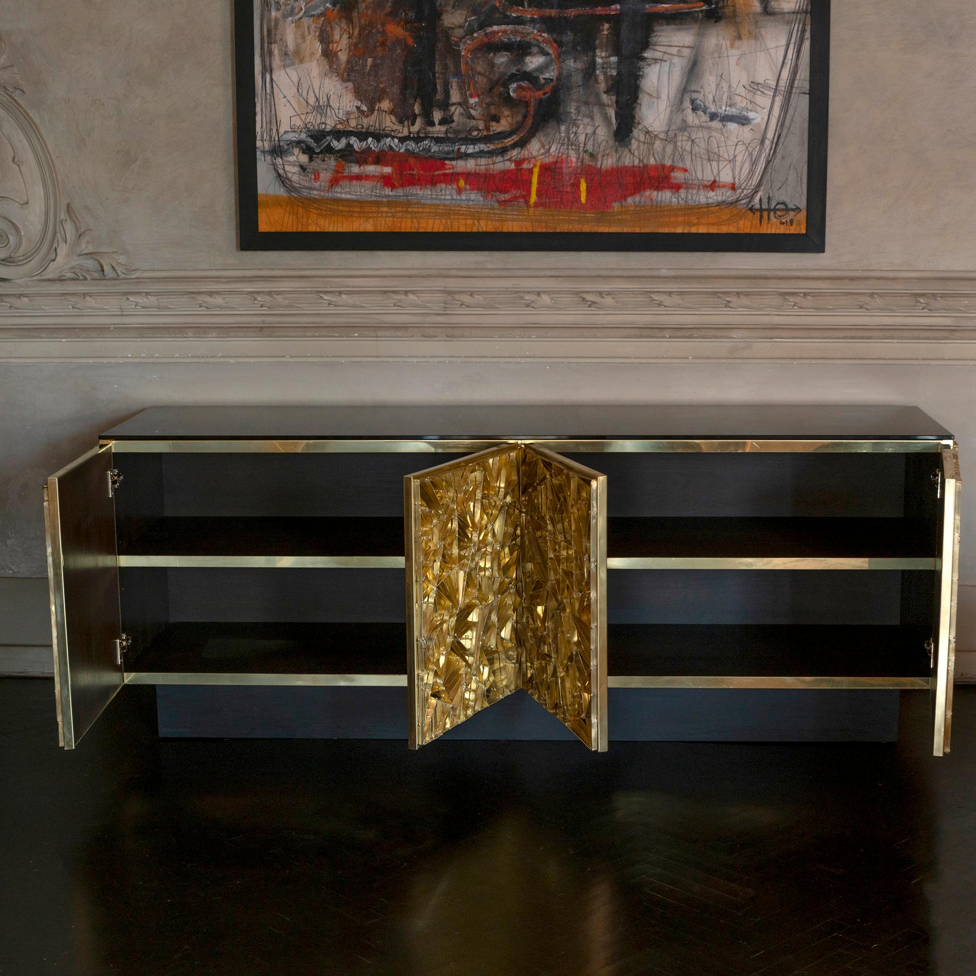 Nest sideboard part of the Flair Edition collection and crafted by local artisans, wood structure covered in natural unvarnished brass and a sculptural and brutalist brass grid, this gives the piece a vintage patina that is the main characteristic