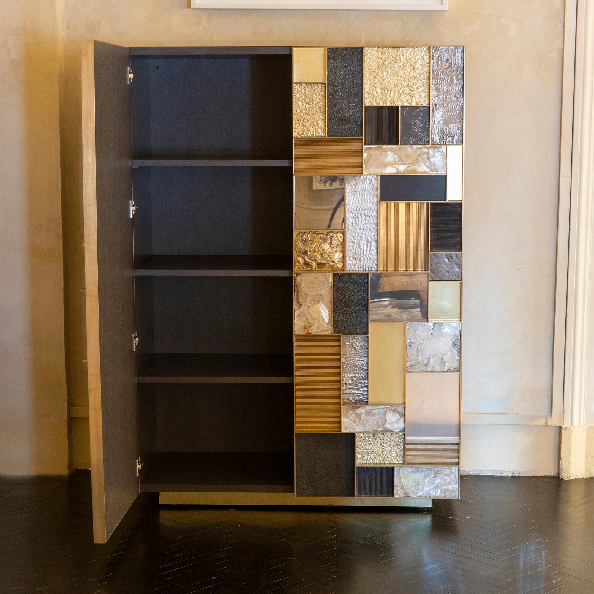 Contemporary one of a kind cabinet part of the Flair Edition collection, structure covered in painted grey steel, sculptural doors with a geometric pattern and composition of brass wire, hammered brass, natural iron, hammered iron, gypsum crystal,