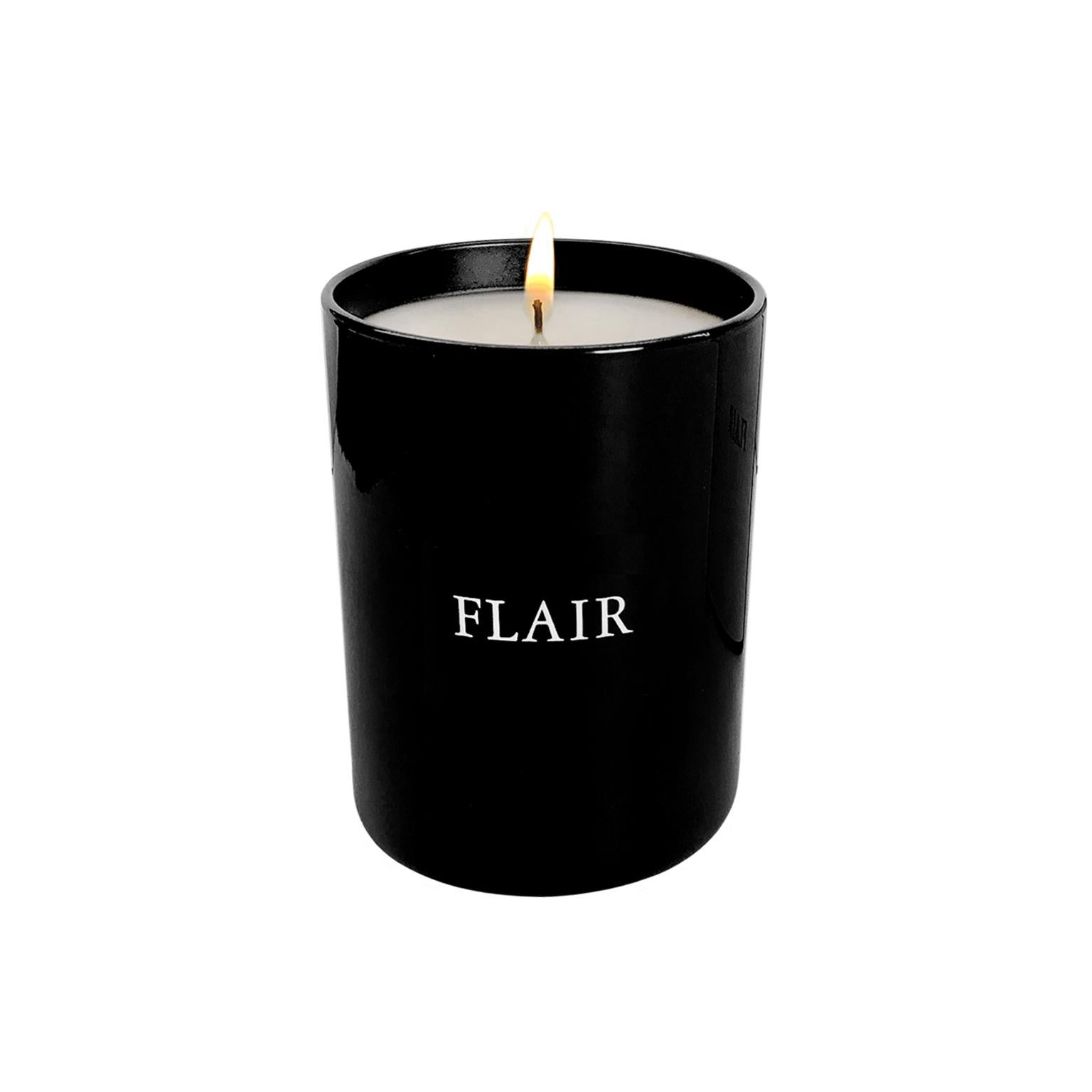 FLAIR Home collection candle in classic dark amber. Deep and mysterious, featuring a base scent of dark amber enhanced with notes of precious wood, tobacco, caramel and oak moss. Black glass 6.5 oz container. Made in France.