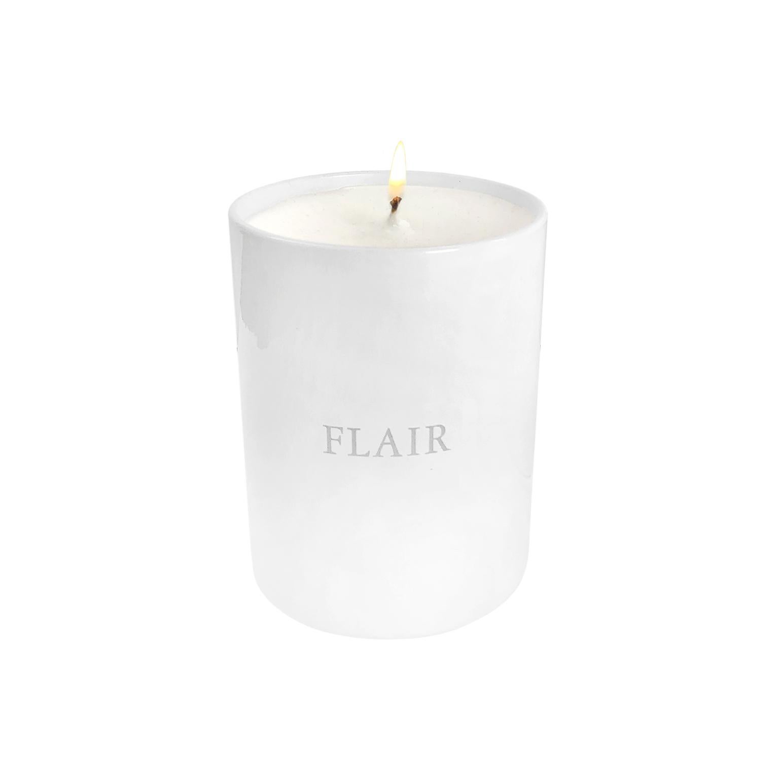 FLAIR Home collection candle in white musk. Light and effervescent, featuring a base scent of powdery white musk enhanced with notes of lavender, vanilla, and lemon. White glass 6.5 oz container. Made in France.