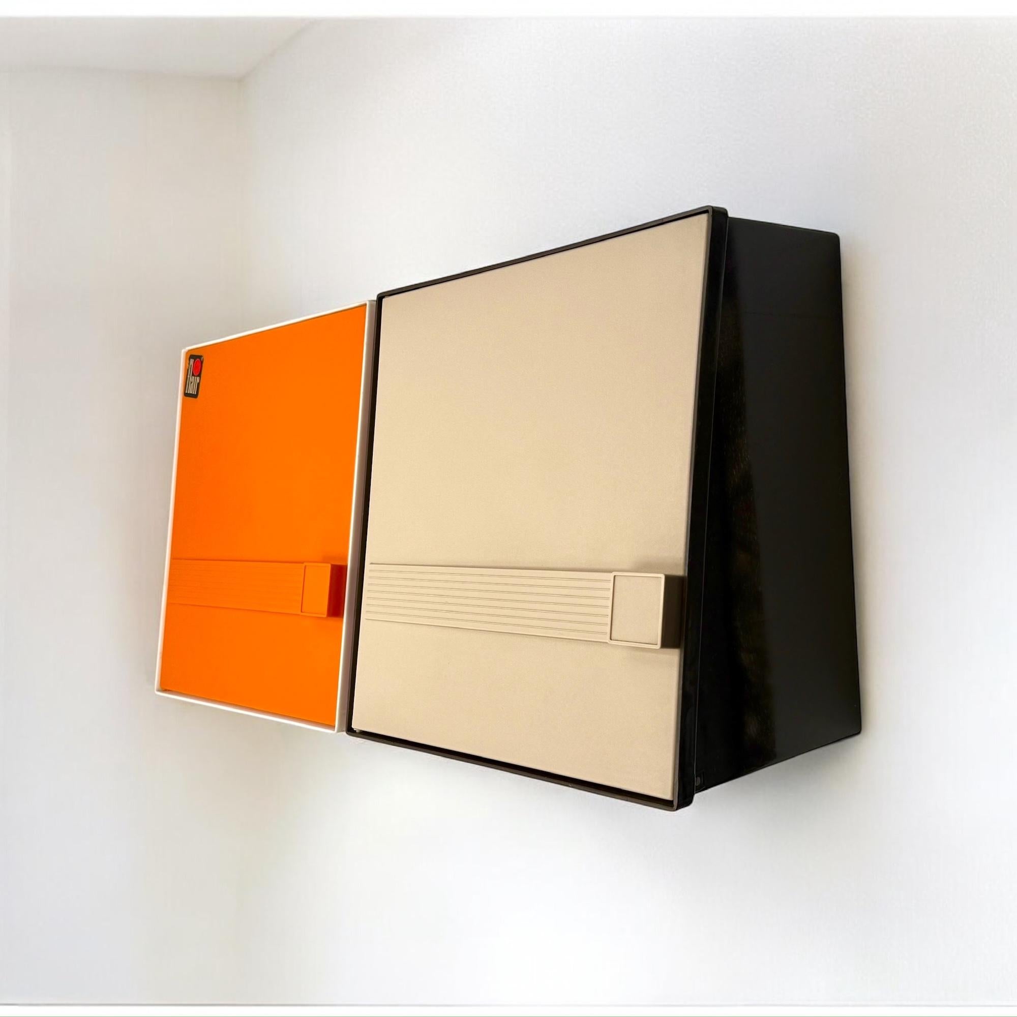 This pair of wall-mounted storage units was designed by Flair in the Netherlands during the 1970s, a period known for bold experimentation in color, shape, and materials. Crafted from rigid thermoformed plastic, the two pieces feature a sculptural