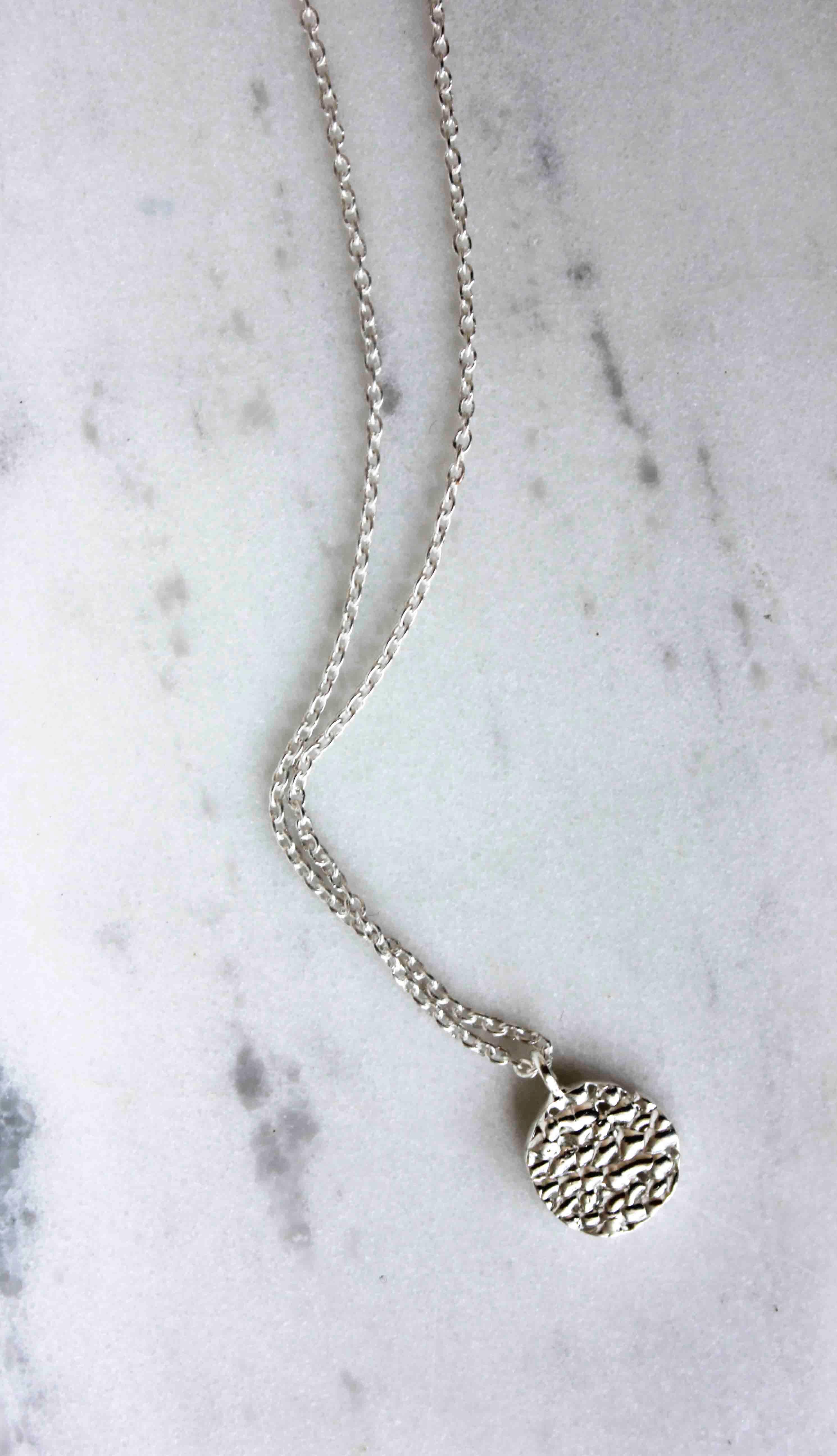 The Flakes Necklace is handcrafted from eco silver.

Is an everyday dainty necklace with an impressive texture, which strung on a 44cm chain.

The Flake Necklace can be worn alone or layered.

Diameter: 1.2 cm

Chain length: 44 cm