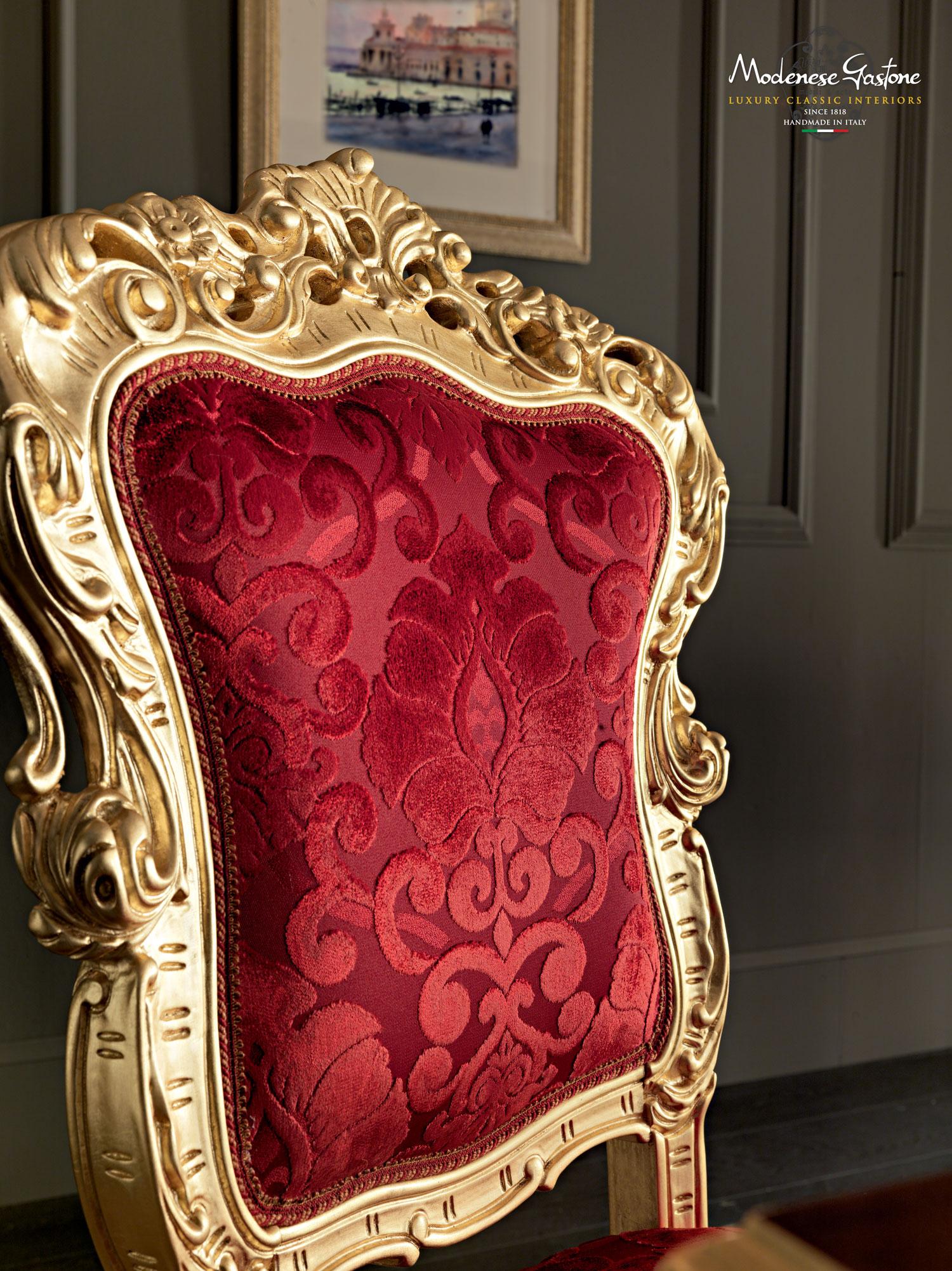 Specially designed dining chair by Modenese Luxury Interiors take on a true baroque style. This wonderful chair is a great head turner piece in any living space with its flamboyant red damascus upholstery being highlighted by the solid walnut curved
