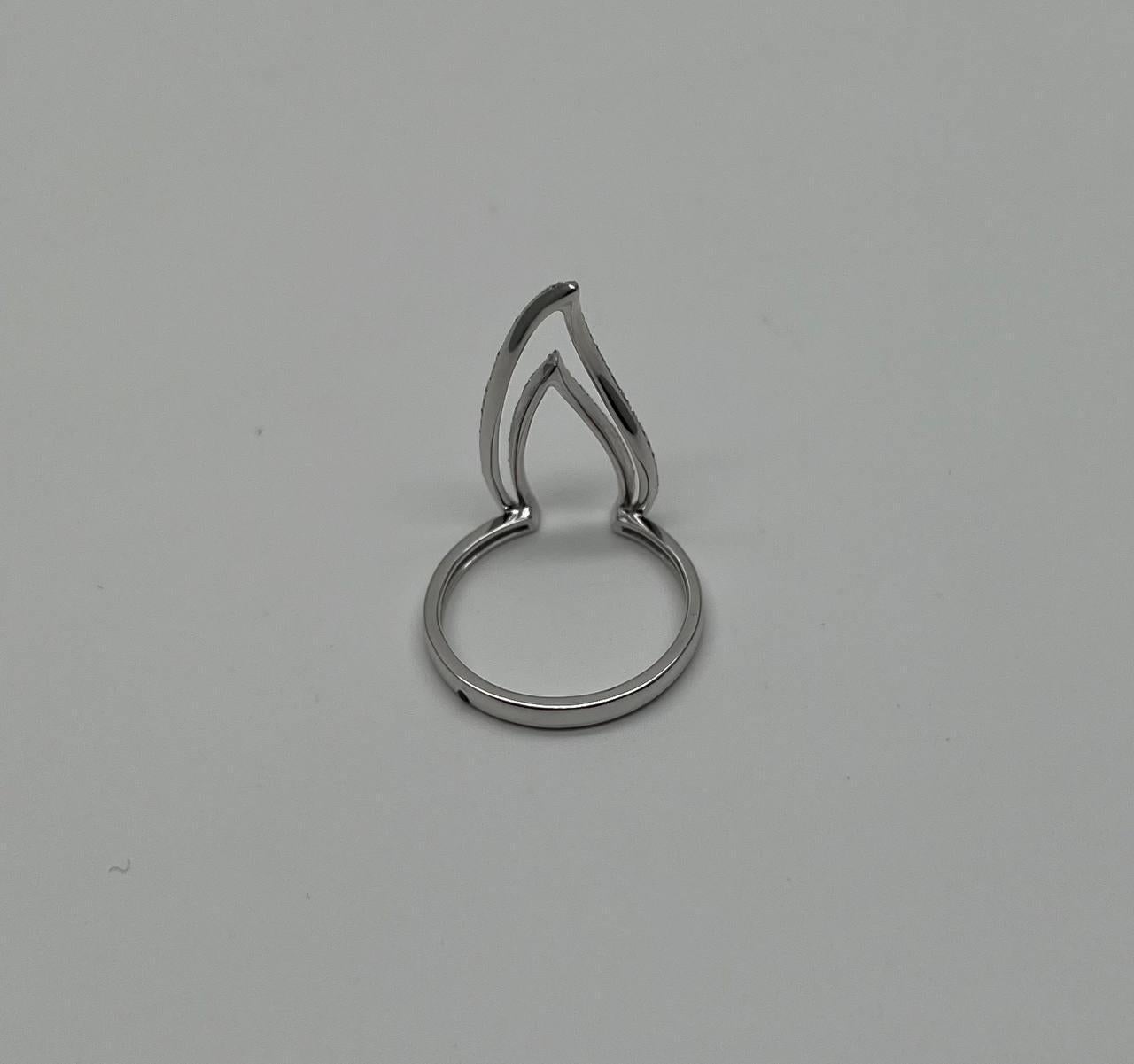 A modern and elegant ring featuring a unique open design with two intersecting curves. The ring is crafted in a sleek metal finish, with delicate pavé detailing along the curves, adding a subtle sparkle. Expertly designed for a contemporary look,