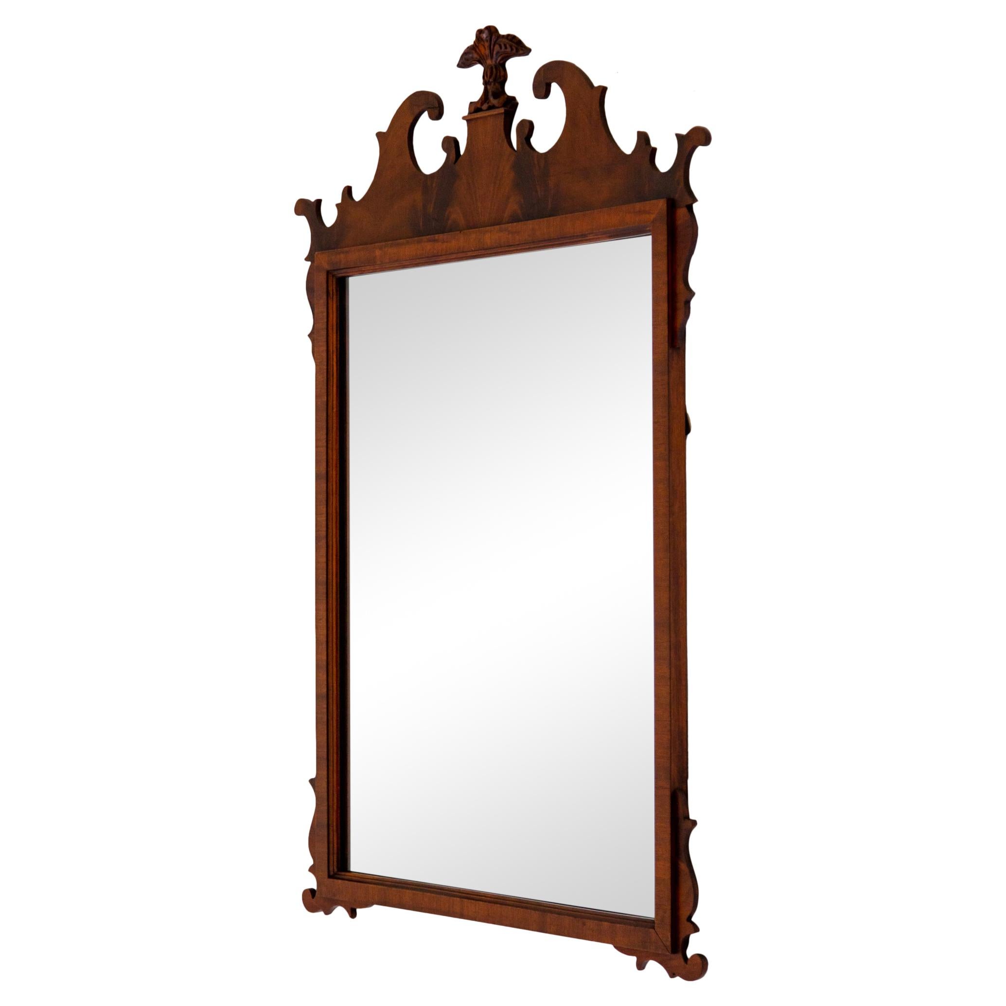 Vintage flame mahogany Chippendale style mirror with Prince of Wales three-feather crest, circa 1940s. Mirror inside frame measures 21