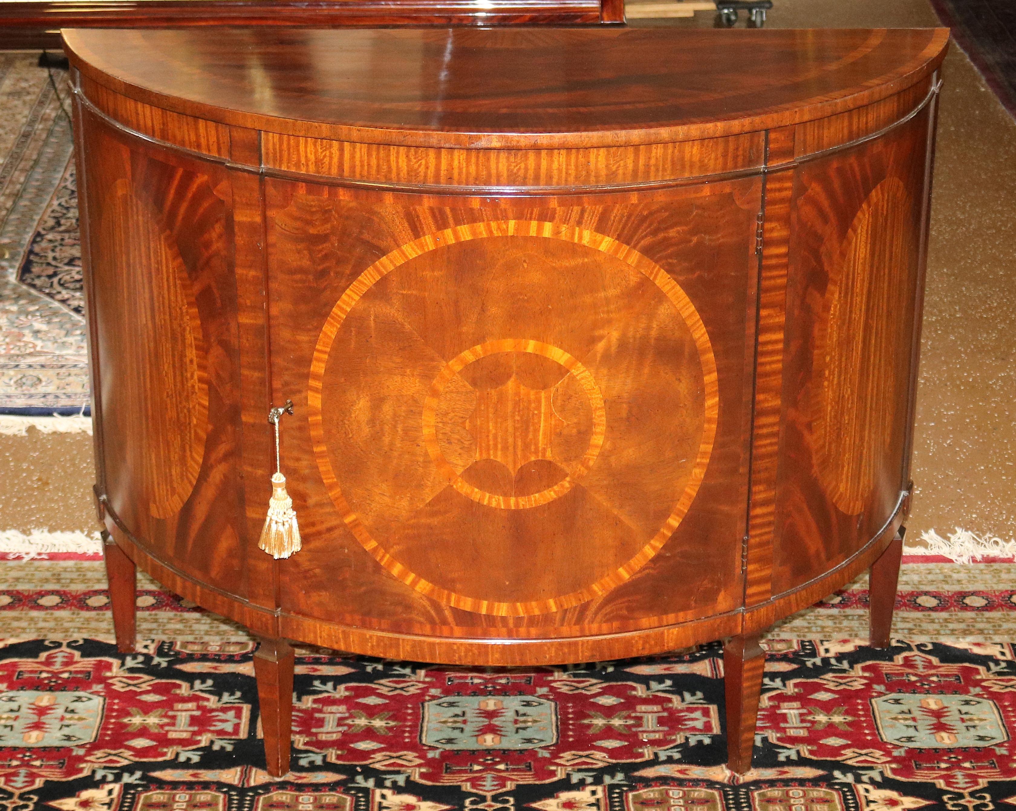 Flame Mahogany Historic Charleston Collection Demilune Chest Server Buffet

Dimensions : 48ʺW × 20ʺD × 38ʺH

Beautiful server made by Baker furniture for their historic Charleston collection. The mahogany grain and inlay are killer! The server is in