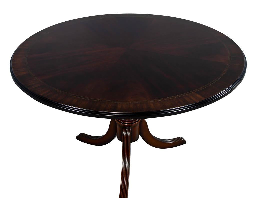 Flame mahogany round Duncan Phyfe breakfast parlor foyer table. Classical styling on this fine example of a traditional center table makes it a timeless creation for generations to come. With a beautiful bookmatched sunburst centre flame mahogany
