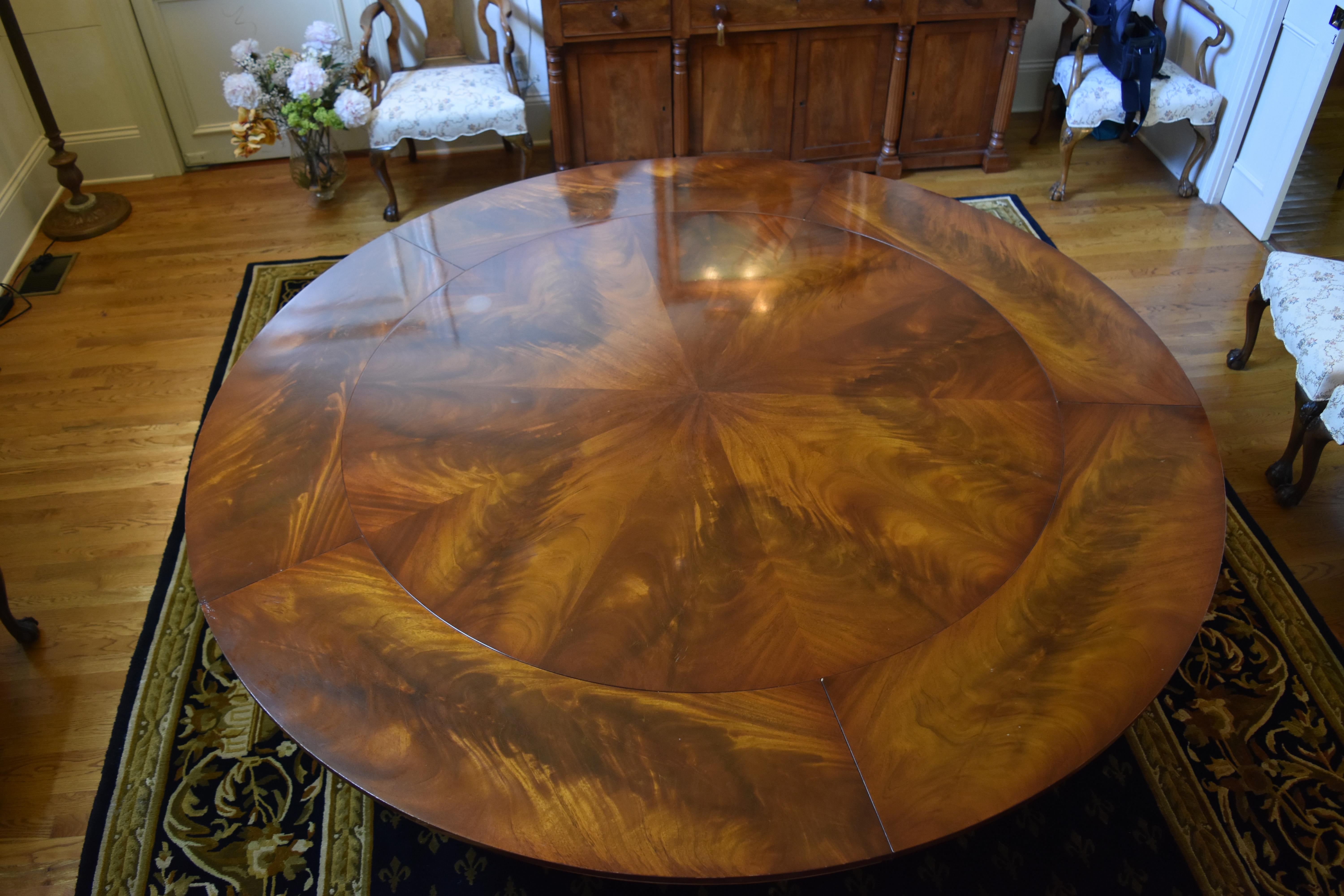 This Regency style 82 inch round flame mahogany dining table with a 4 post pedestal base was purchased new in 2002 from Mill House Antiques in Woodbury, Connecticut. The table has five leaves (each 12 inches) which can be added to the circumference