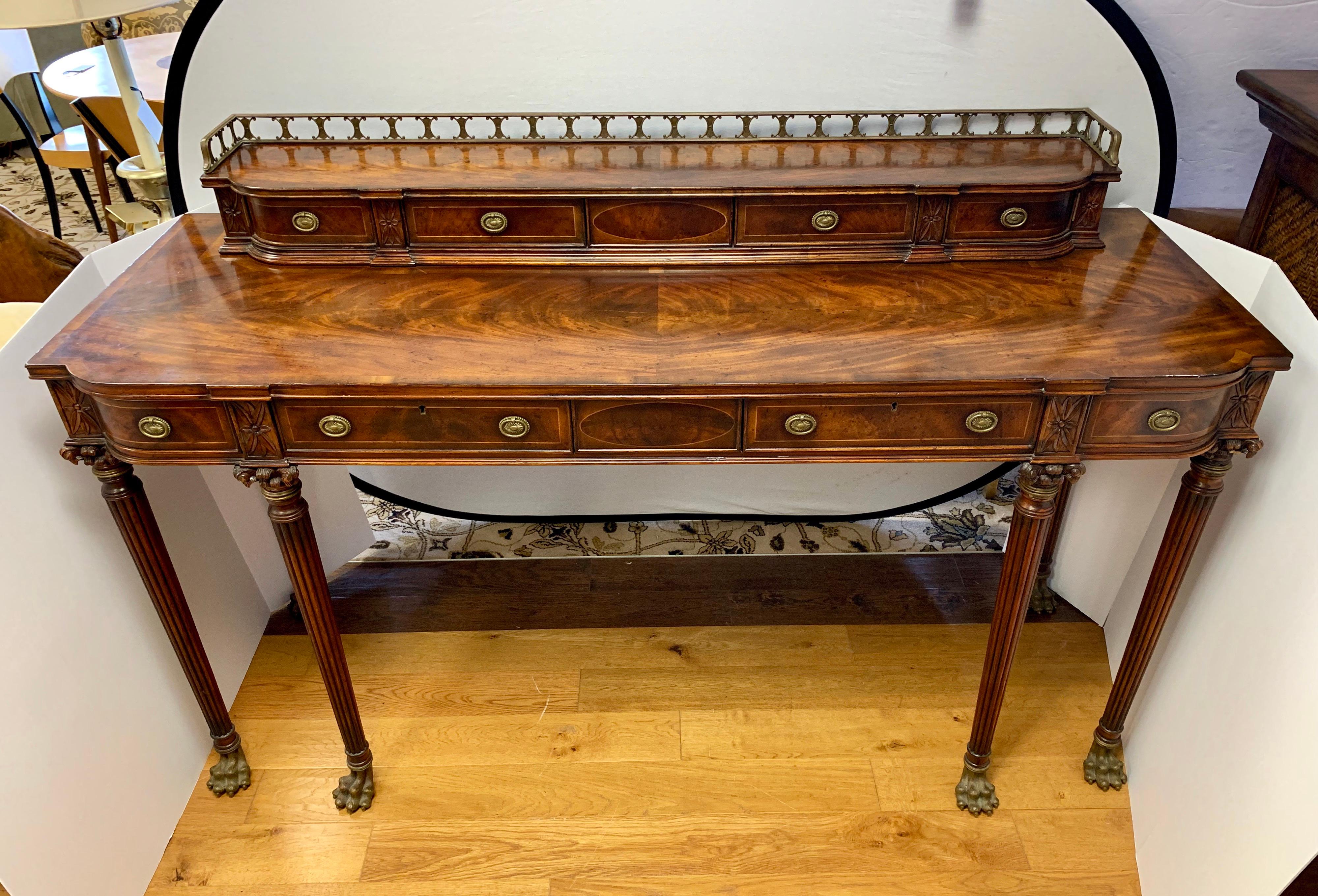 Stunning flame mahogany and brass large console or sideboard with claw feet. It features multiple drawers, some that slide out and others that open left to right. Comes with keys. Retails new for almost
$18,000.00. Good luck.