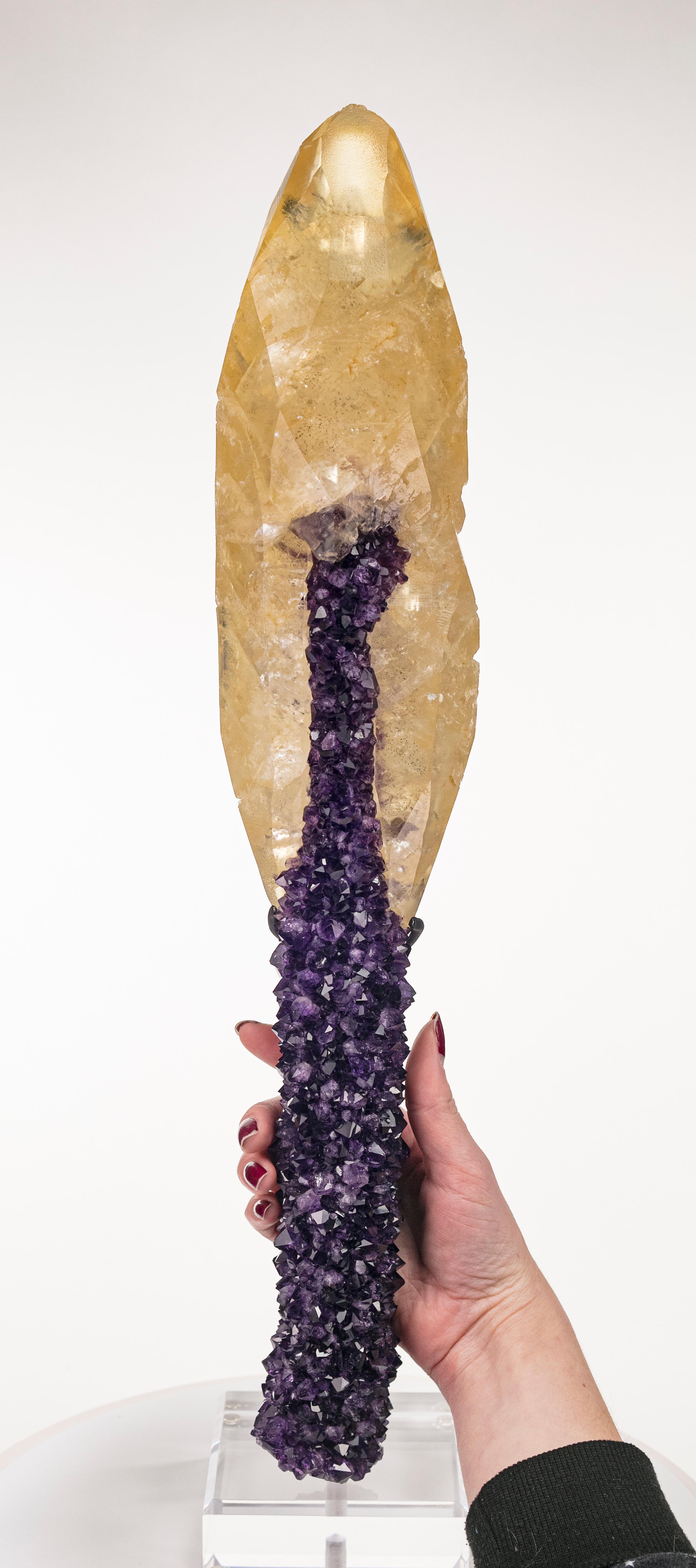 This is a stunning specimen featuring two commonly known species (amethyst and calcite) that have culminated in a wholly unbelievable and unusual composition. Deep, grape-jelly purple amethyst crystals have clustered together to create a lustrous