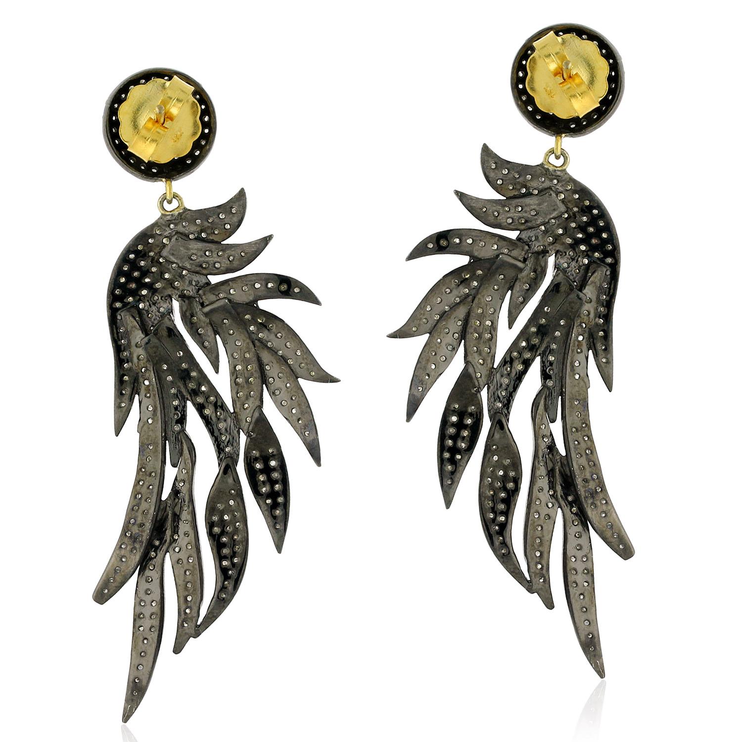 These beautiful flame shaped earrings are made from 14k gold and silver, and feature pave diamonds for a dazzling finish. The unique flame design adds a touch of drama and intensity to any outfit. The diamonds catch the light with every movement,