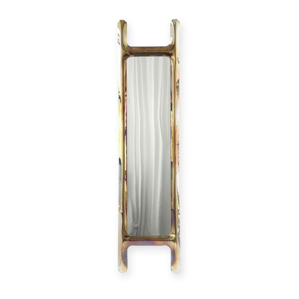 Flamed gold drab sculptural wall mirror by Zieta
Dimensions: D 6 x W 46 x H 188 cm 
Material: Mirror, stainless steel. 
Finish: Thermal colored in Flamed gold. 
Also available in colors: Flamed gold, cosmic blue, stainless steel, or