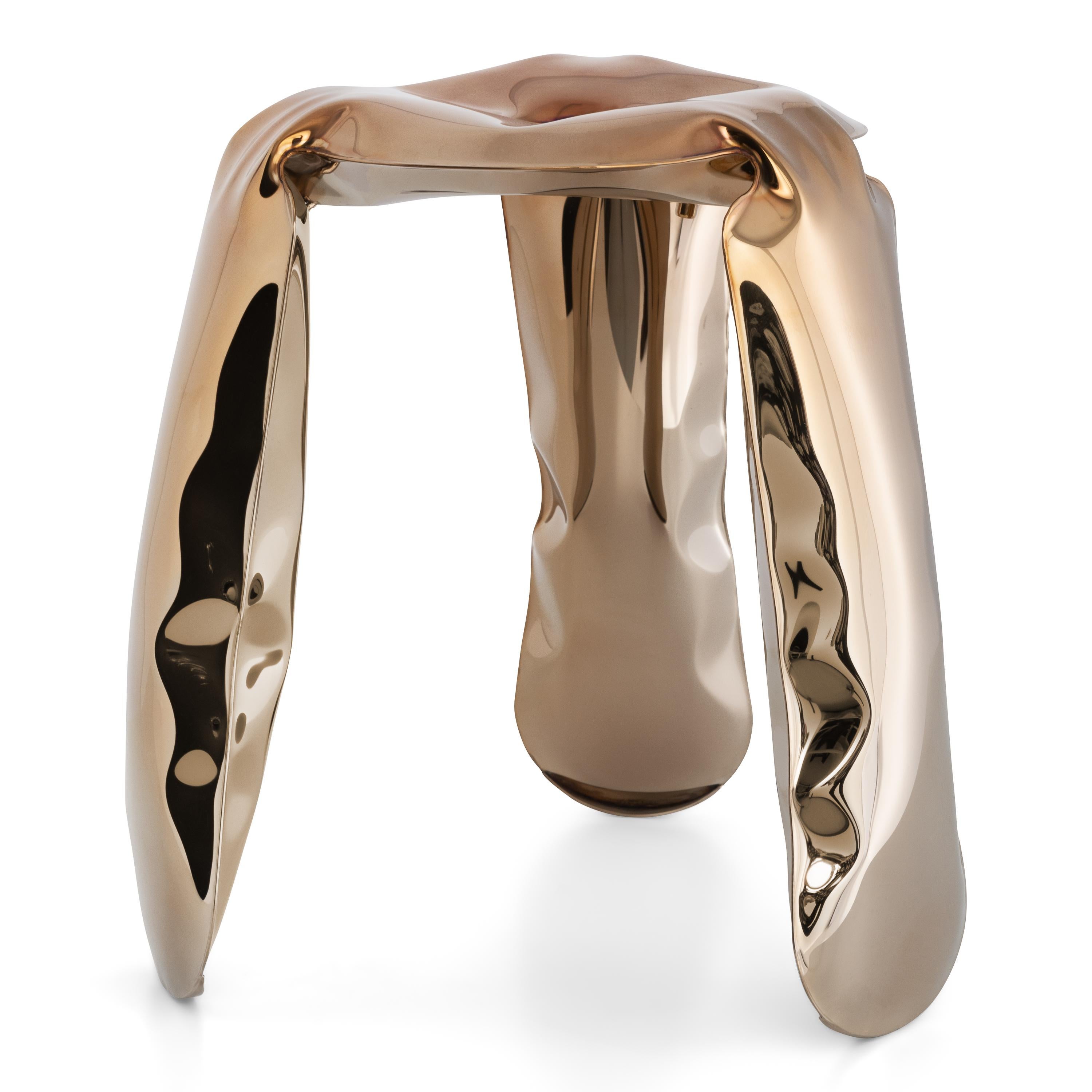 Flamed Gold Mini Plopp stool by Zieta
Dimensions: Diameter 25 x H 38 cm 
Material: Stainless Steel. Carbon Steel. 
Finish: Thermal colored. Flamed Gold. 
Available in colors: Flamed Gold and Deep Space Blue. Available in Stainless Steel,