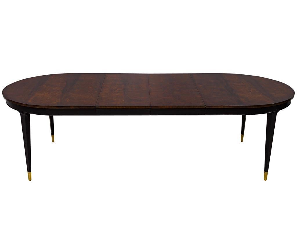 Flamed mahogany dining table Hepplewhite inspired. Beautifully bookmatched hand rubbed finished mahogany flamed top with solid mahogany tapered legs with brass caps.

Table fully extends to a length of 108