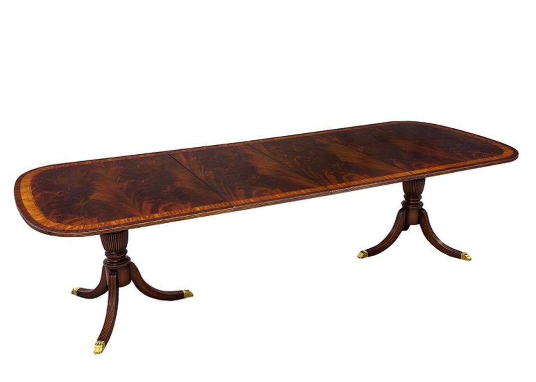 Here we have a stunning top end dining set. The table is made in North Carolina featuring a Classic and gorgeous combination of woods. Adorned with rich flamed mahogany, the table is banded with tulipwood and satinwood that add a lovely colour