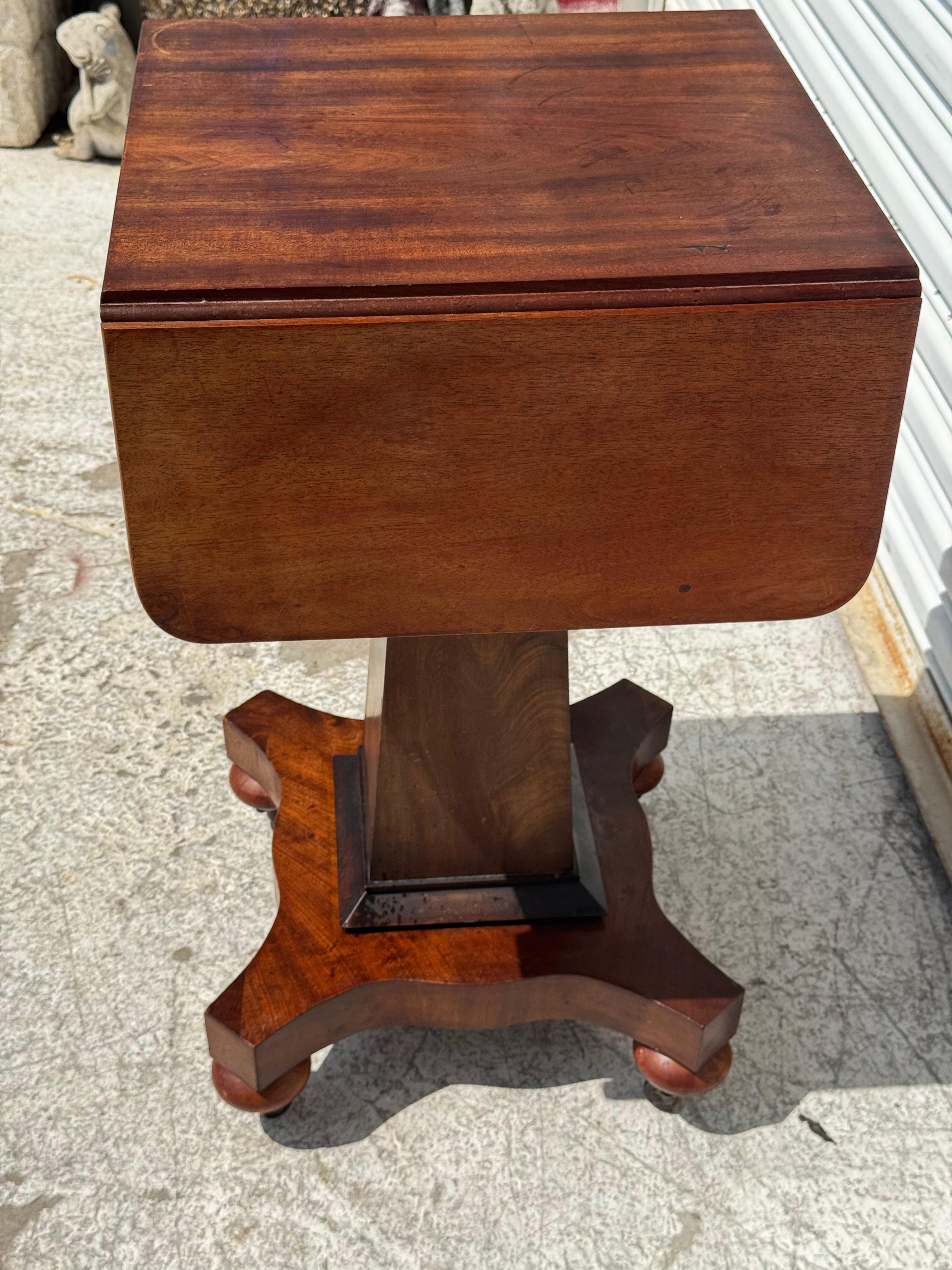 Late 19th Century Flaming Mahogany Empire Revival Drop Leaf Sewing Table by Scheide For Sale