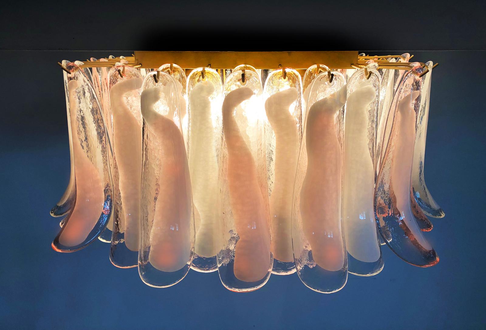 Spectacular ceiling lamp with 64 Murano Glasses. The glasses have two different colors, half are transparent with white spots, half are pink with white spots. Elegant lighting object.
Period: late 20th century
Dimensions: 15.75 inches (40 cm)