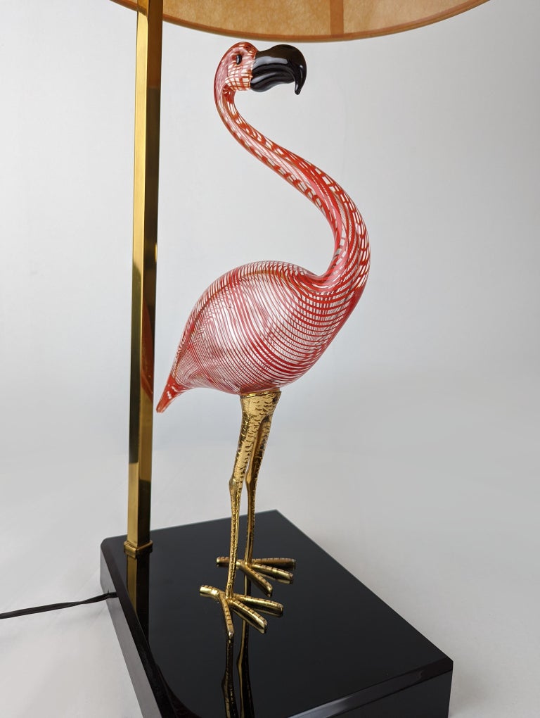 Exclusive flamingo lamp made by the great master sculptor Licio Zanetti in Murano glass and bronze legs. Natural themes such as birds were the most outstanding works of Zanetti, each one of them unique works made by hand. The lamps made by Zanetti