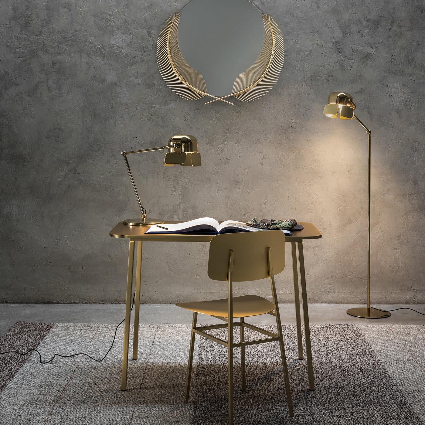Nika Zupanc designed this elegant lamp where the light is projected through four adjustable flaps and the minimalist structure in steel is evocative of a flamingo's leg. The golden finish will brighten up even the coldest of corners.
 