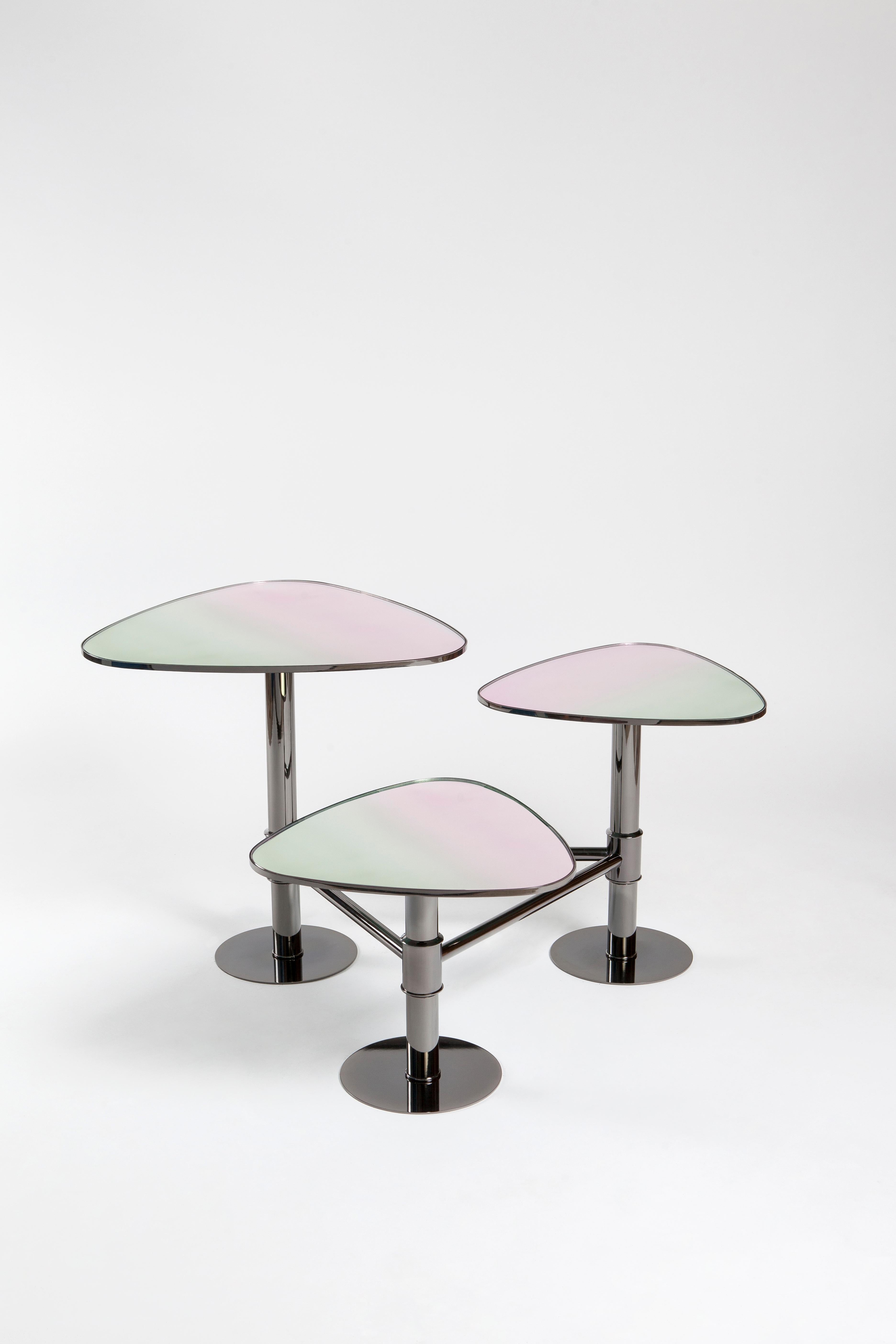The threefold metal bodied, marble center table of Kontra.    
Center table, coffee table.