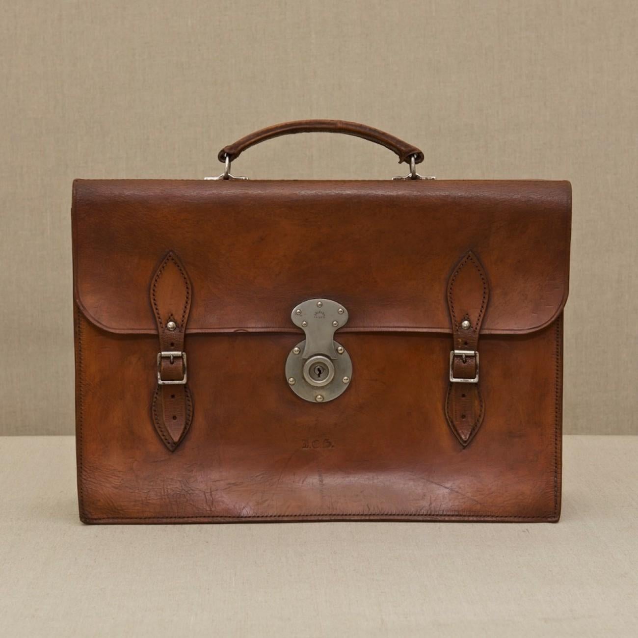 A handsome mid tan leather three pocket briefcase with two buckled straps and central nickel-plated catch, circa 1950.

Dimensions: 41.5 cm/16? inches (length) x 29 cm/11½ inches (height) x 6.5 cm/2½ inches (thick)

Bentleys are Members of LAPADA,