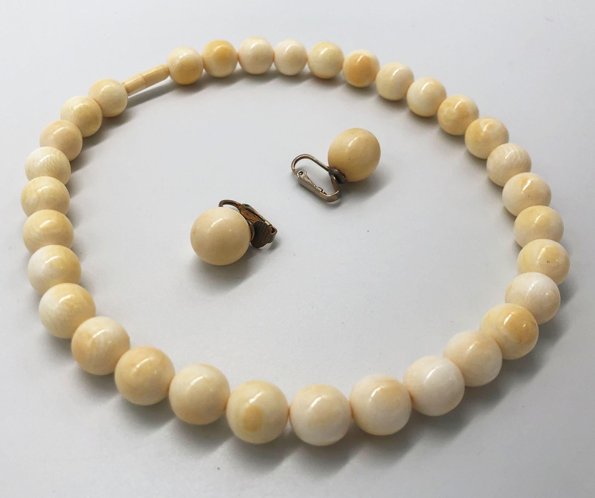 Emanating old-world charm, this bone-beaded necklace choker with matching clip-on earrings both feature hand-shaped beads with silver studs on the clip-on earrings. Delicately crafted beads exude sophistication, complemented by their simple form