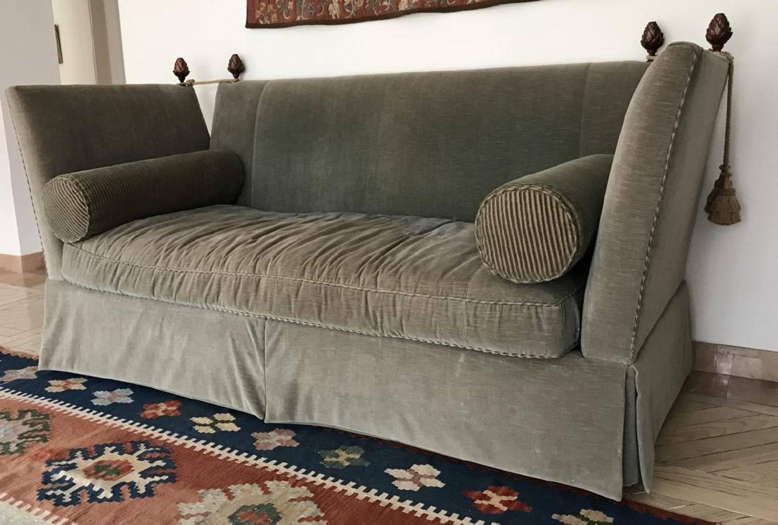Elegant custom upholstered vintage sofa adorned with finials, tassels and pair of bolster pillows. Measures 46 x 88 x 39 inches. Upholstered in grey velvet with contrasting striped welt. This is a 1980s copy of the original style that dates back to