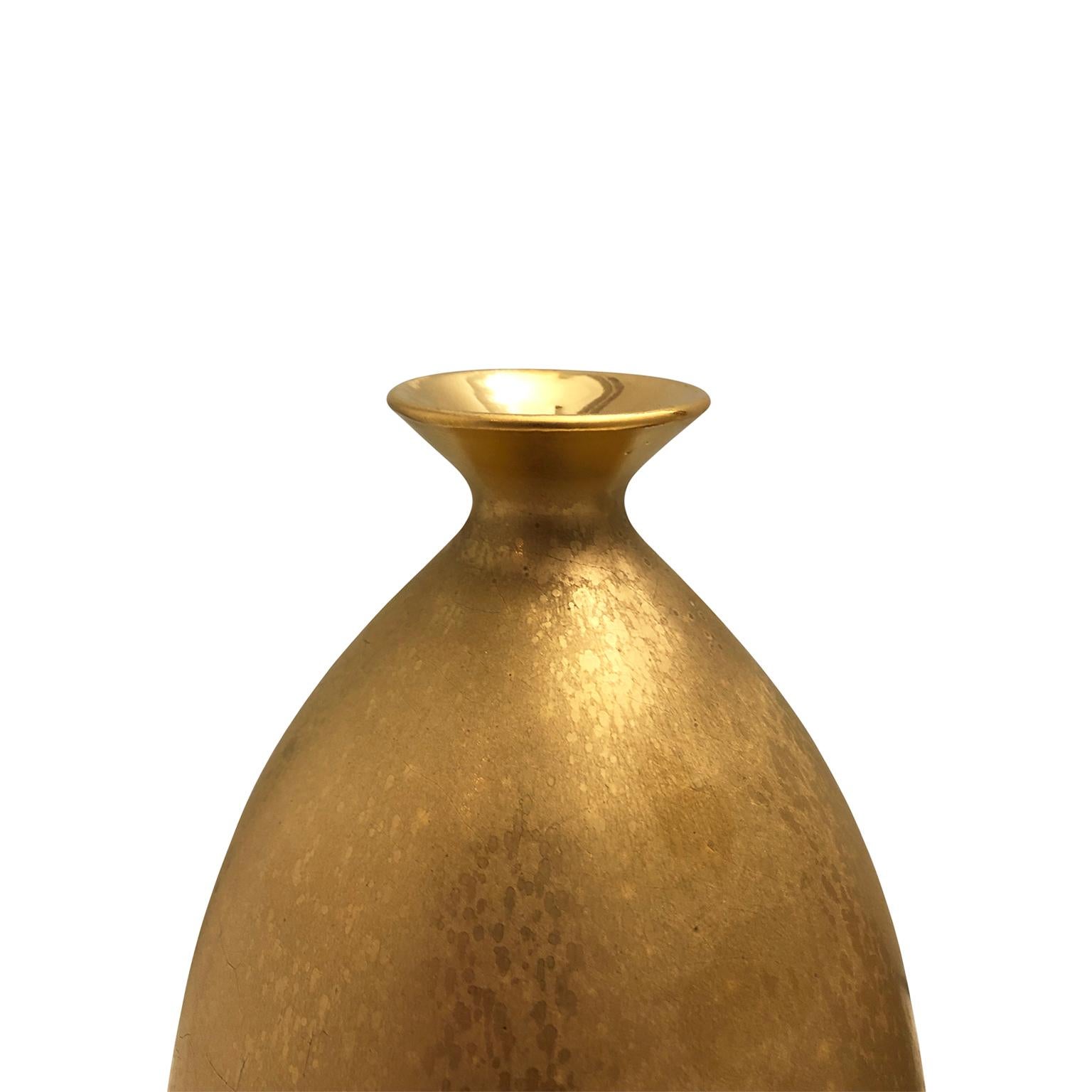 Medium ceramic bottle vase with flared bottom and burnished gold lustre glaze by Sandi Fellman, 2019. 

Veteran photographer Sandi Fellman's ceramic vessels are an exploration of a new medium. The forms, palettes, and sensuality of her photos can