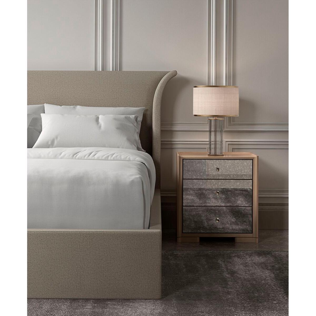 An elegant US king-sized upholstered bed frame featuring a high headboard that is flared out and curves gently at the sides. The frame is wrapped in a medium oatmeal color fabric with a subtle textured finish, which suggests a contemporary design