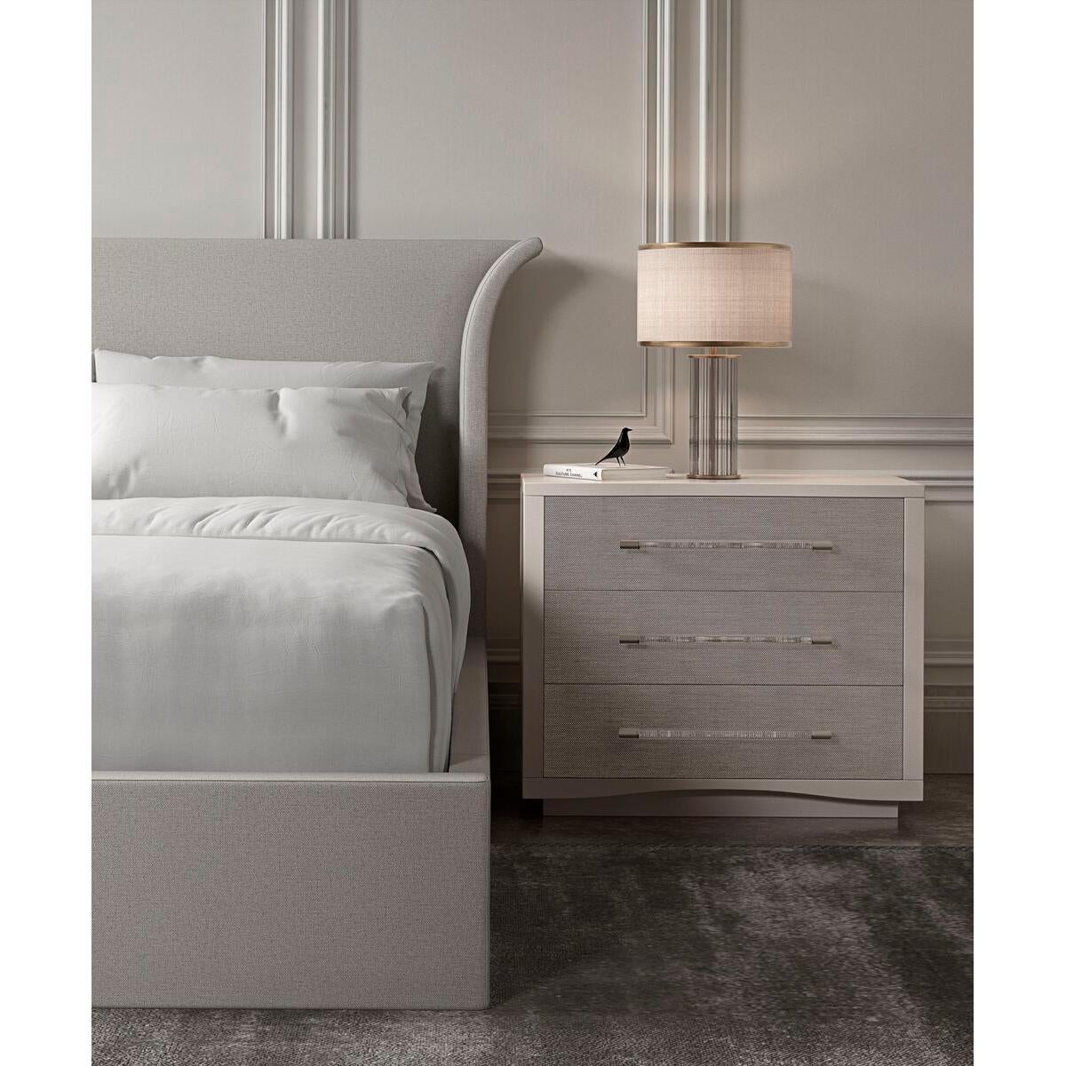 An elegant US queen-sized upholstered bed frame featuring a high headboard that is flared out and curves gently at the sides. The frame is wrapped in a light natural color fabric with a subtle textured finish, which suggests a contemporary design