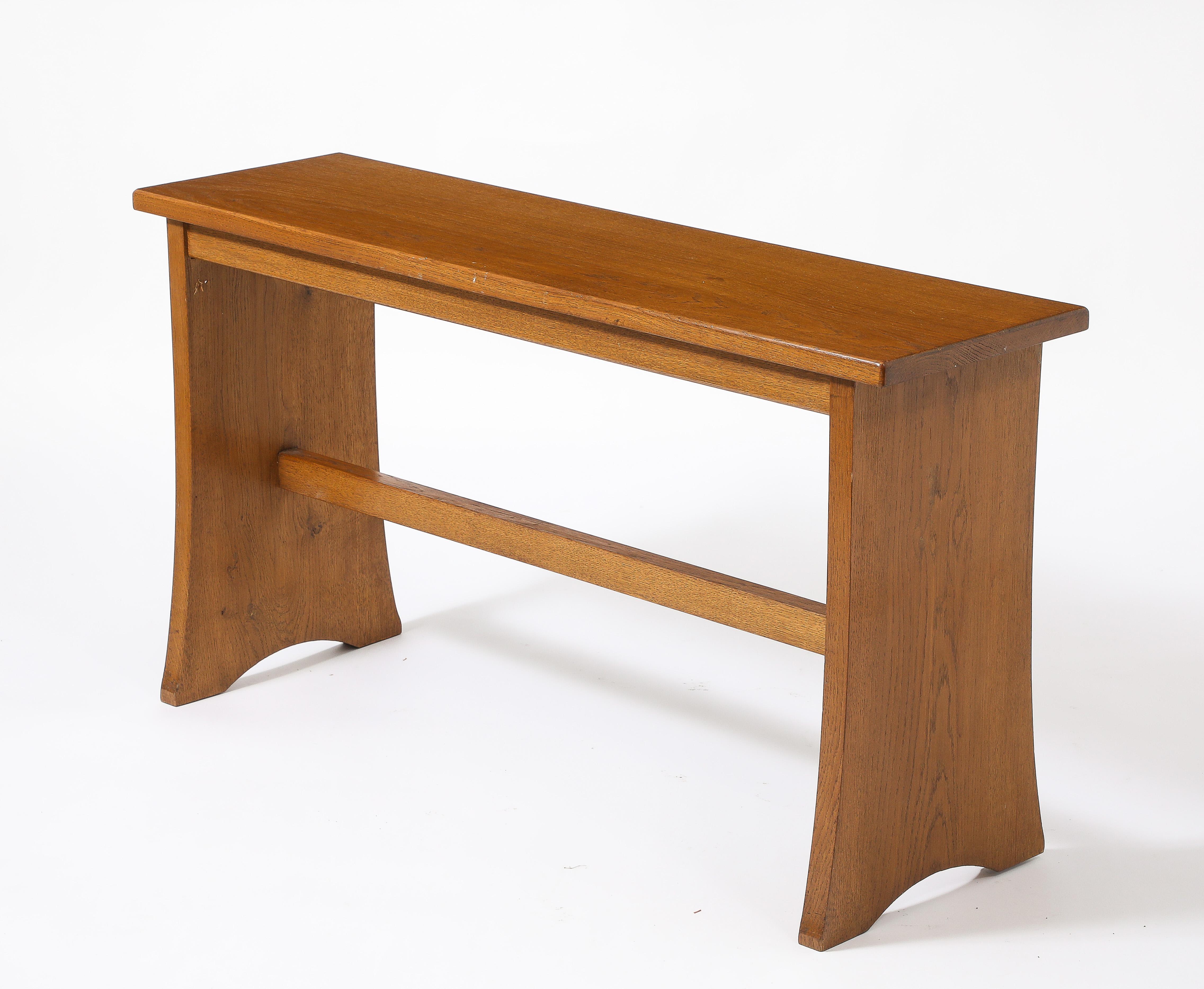 Solid oak console with flared legs.