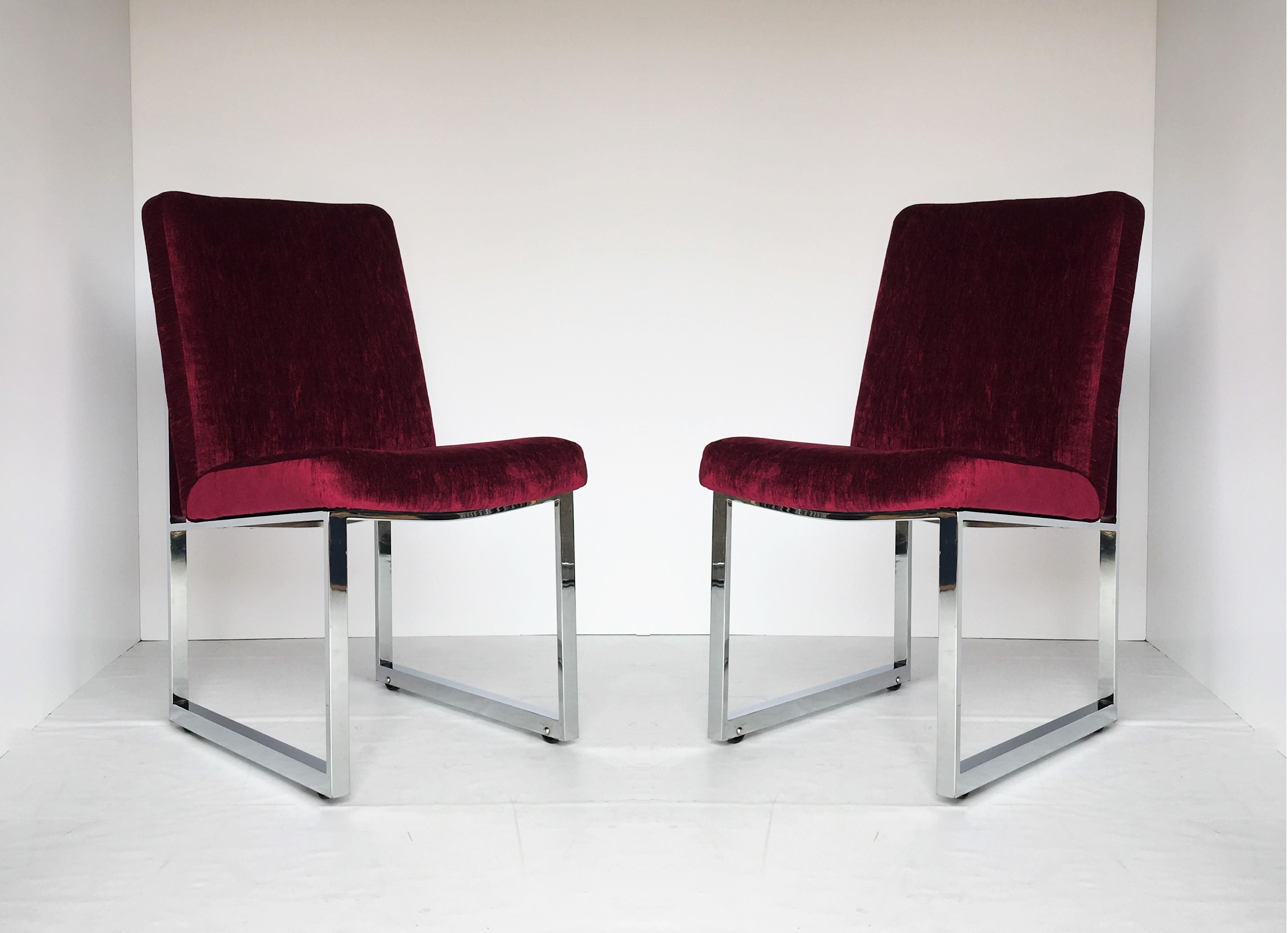 These hard to find and highly coveted set of original flat bar dining chairs designed by Milo Baughman for Thayer Coggin, circa 1976. The chairs feature fully re-upholstered bodies over polished chrome frames. Each chair has a set of four tiny