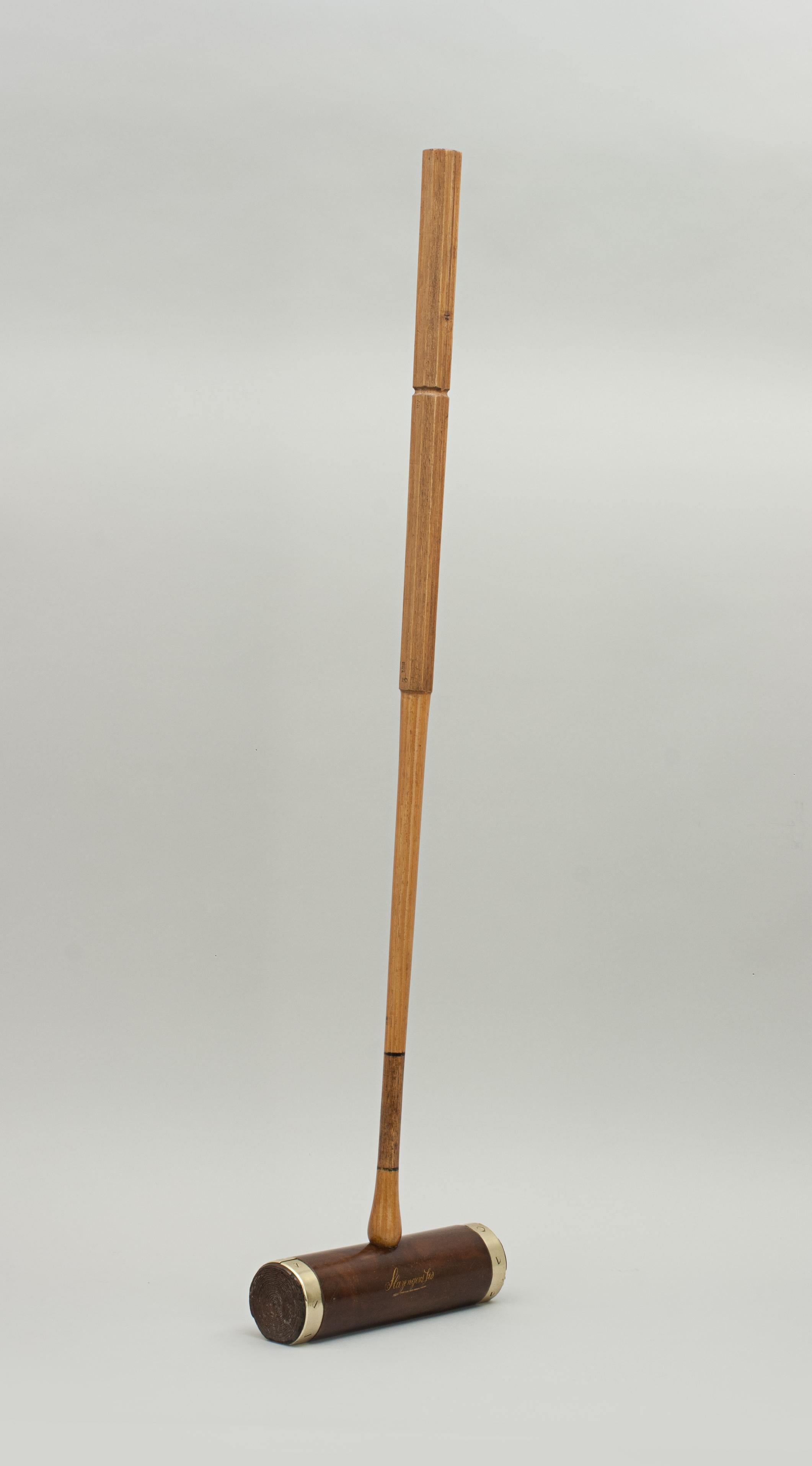 Antique Slazenger 'Corbally' Croquet mallet.
A brass bound flat bottom croquet mallet by Slazenger with a Lignum Vitae head. The mallet head has 'Slazengers Ltd' and 'The Corbally' written in gold on the side and it is fitted with an octagonal