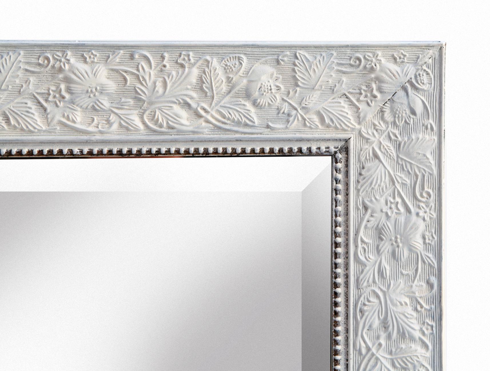 Rectangular mirror set within a flat wood frame featuring delicate beaded trim along the inner edge. 
The frame is adorned with a subtle floral 
leaf pattern.
Low profile beveled mirror is ideal for entryways, bedrooms or powder room.
Wired to