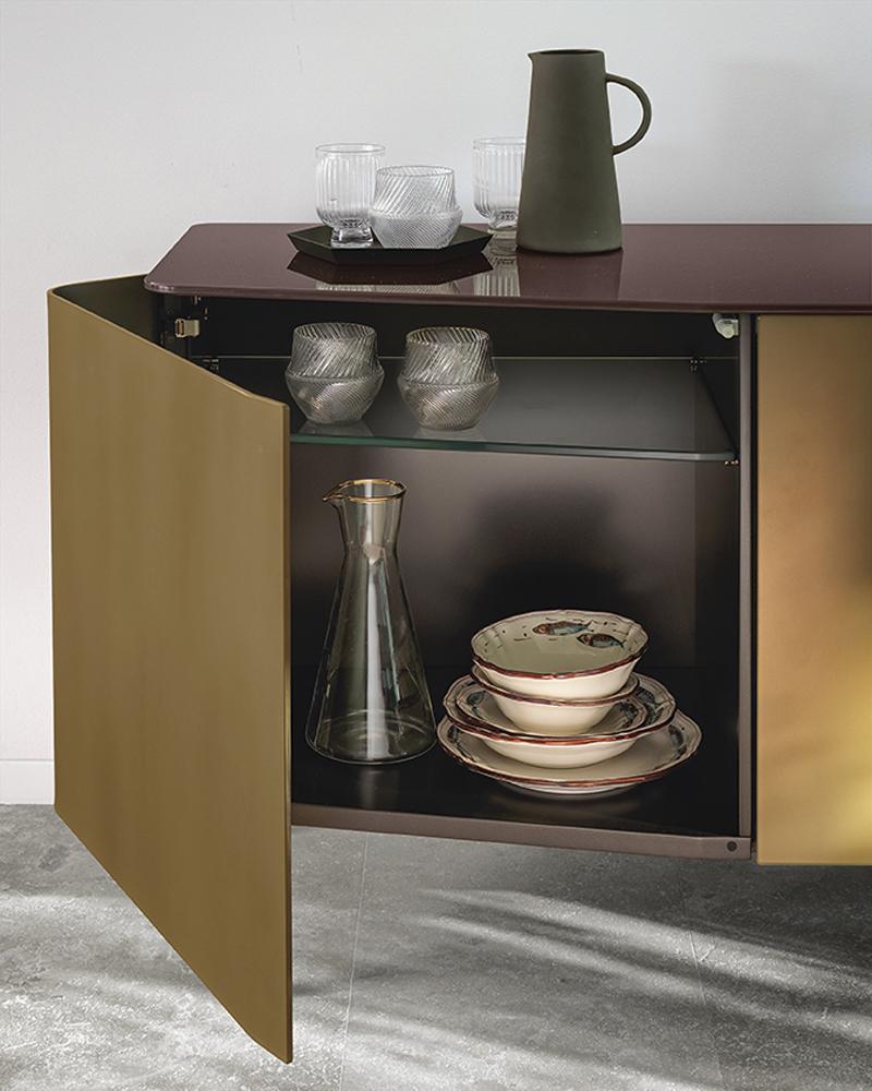 Sideboard flat glass with structure in lacquered wood.
Doors in 6mm extralight curved acid-etched glass in 
gold brown finish. With 10mm extralight black-lacquered
flat glass top. L180xP50xH72cm, price: 10900,00€
Also available with doors in 6mm
