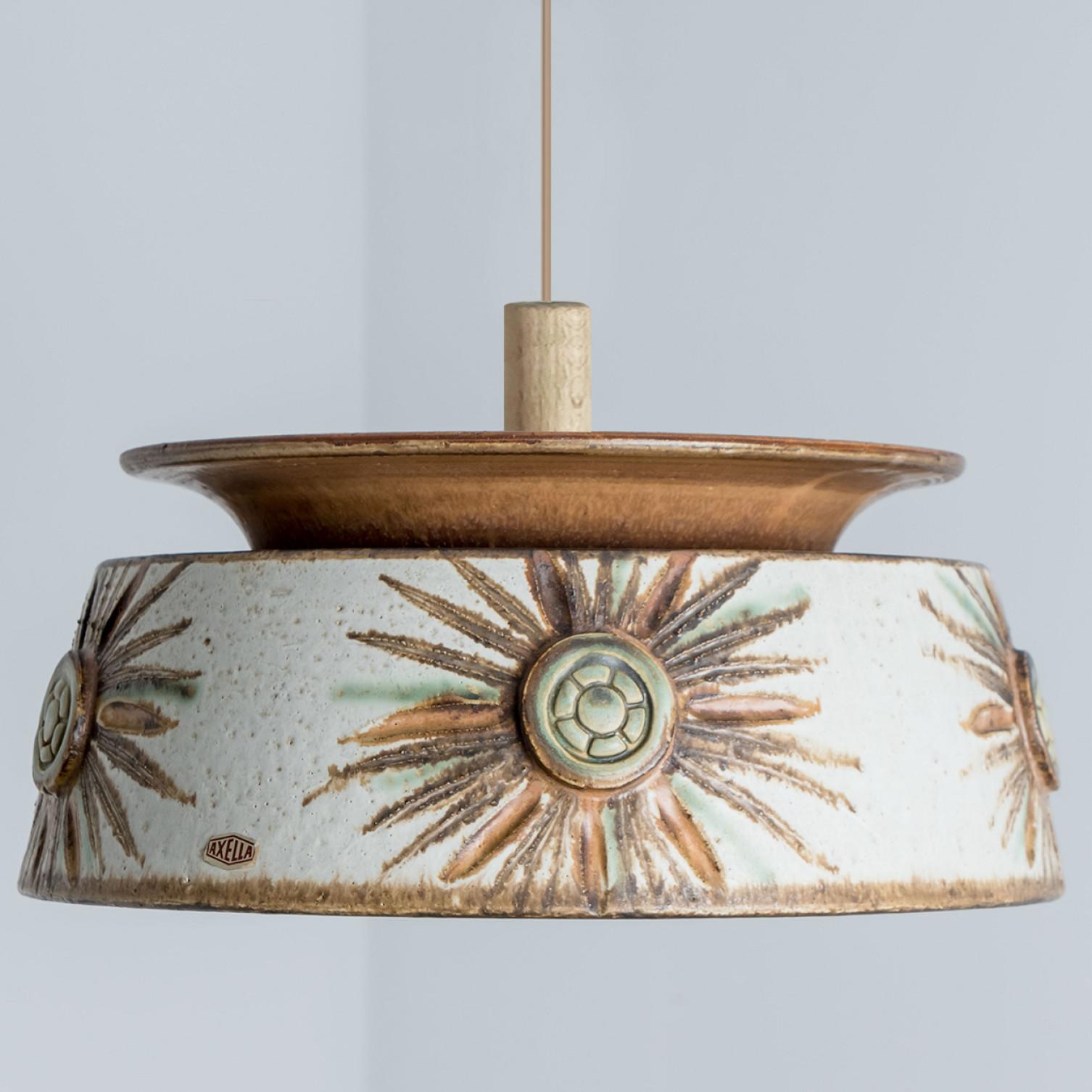 Stunning round hanging lamp with an unusual shape, made with rich brown and light blue colored ceramics, manufactured in the 1970s in Denmark. We also have a multitude of unique colored ceramic light sets and arrangements, all available on the