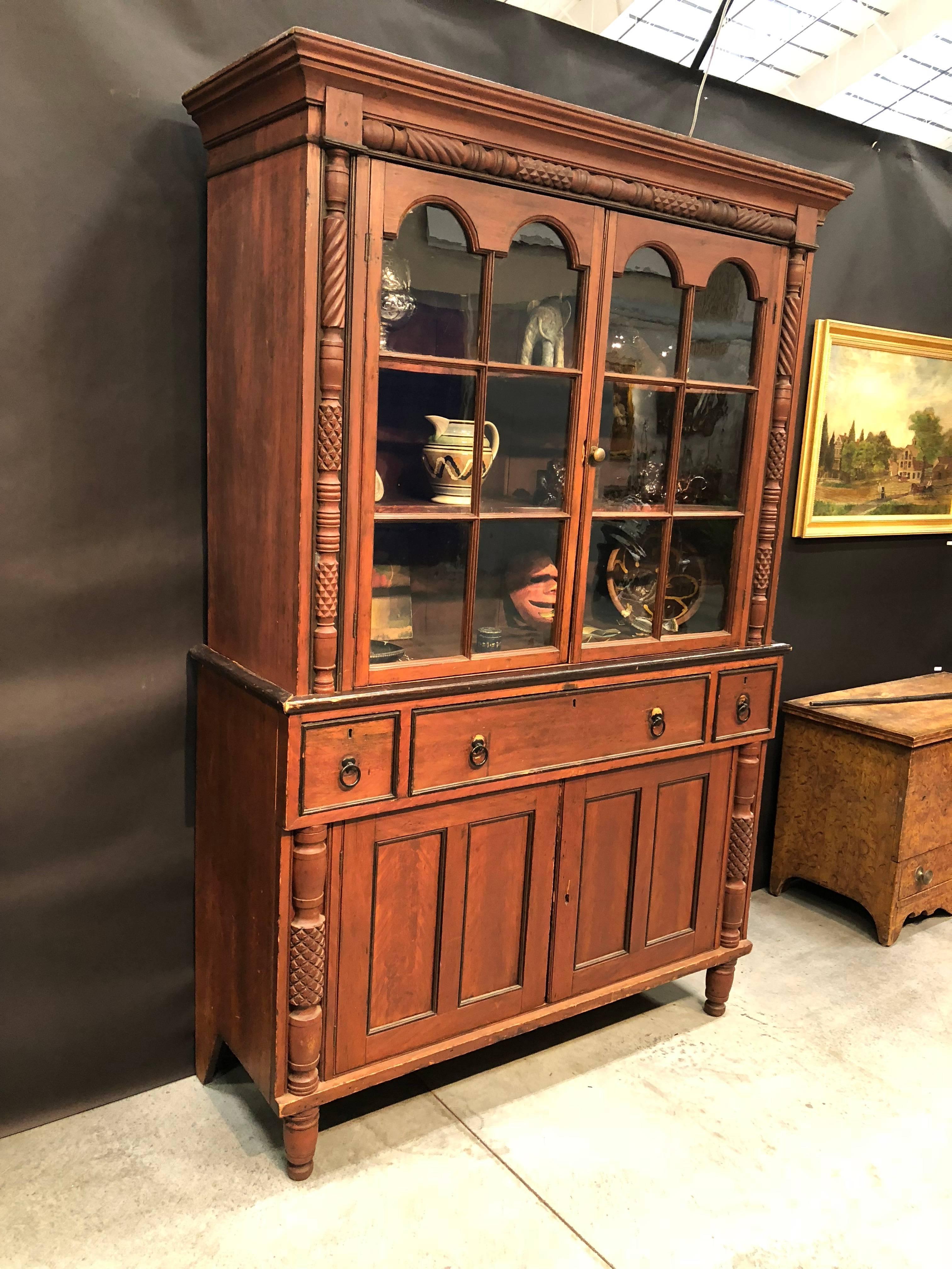Flat wall cupboard two-piece red painted surface Hackensack, New Jersey, circa 1820.
Red paint decorated surface and two six pane glass doors base consisting of three drawers and two doors
Standing on turn feet all original.
 