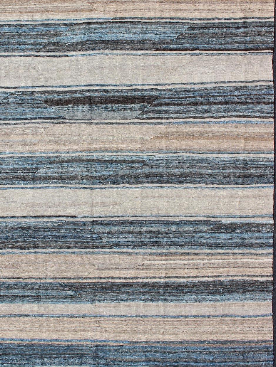 Flat-weave Kilim rug with stripes with modern design in shades of blue, taupe, charcoal and ivory, Keivan Woven Arts / rug afg-27798, country of origin / type: Afghanistan / Kilim

This playful piece features a Classic stripe design that evokes