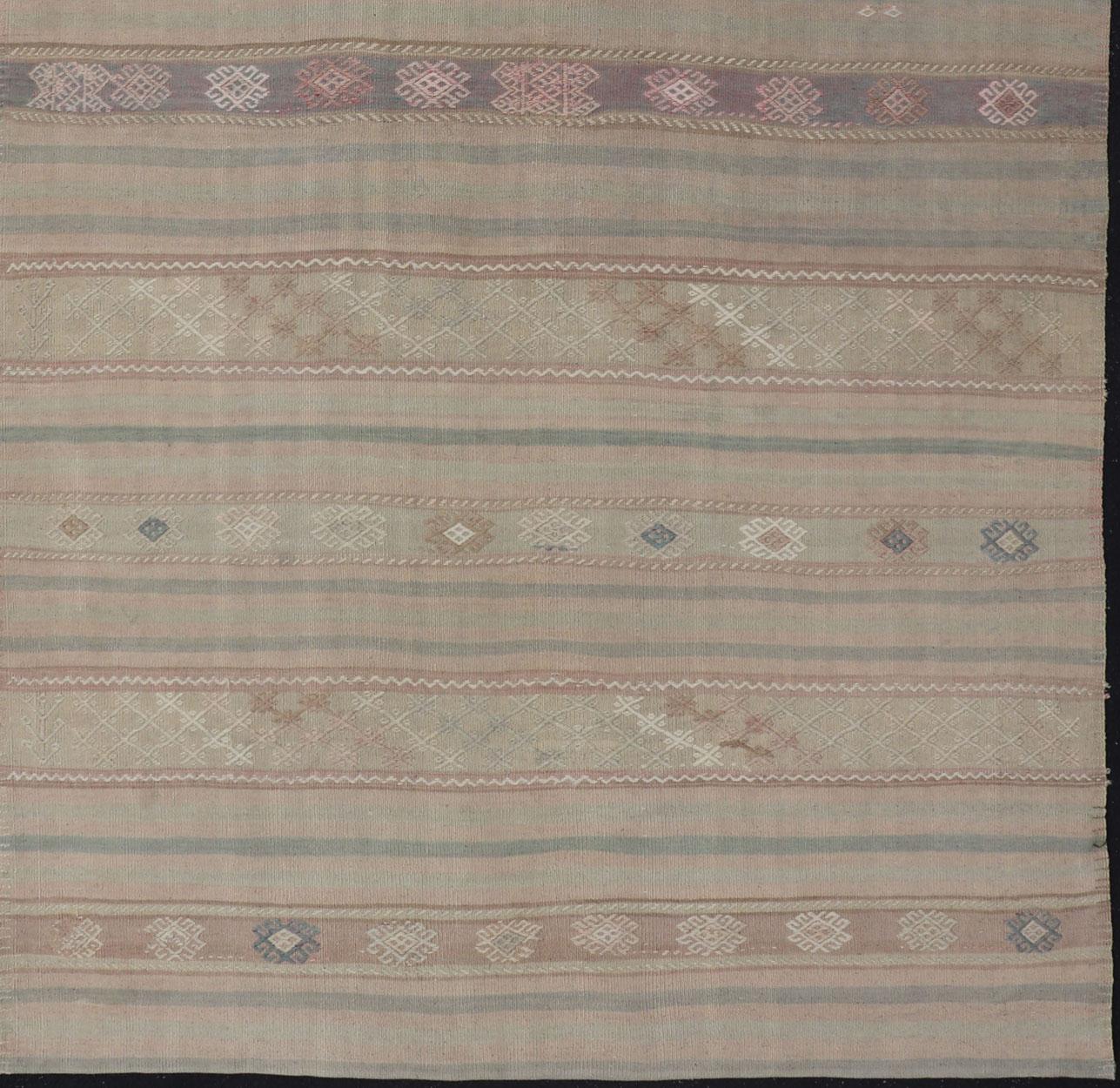 Wool Flat-Weave Turkish Kilim with Embroideries in Earthy Tones and Hints of Pink For Sale