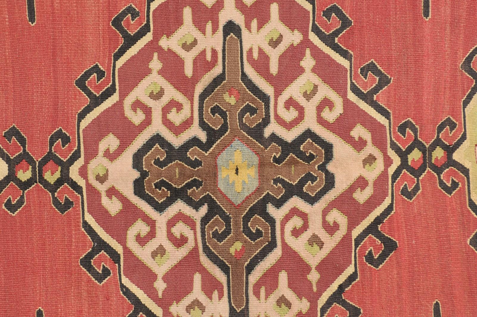 20th Century Flatweave Area Rug in Reds, Tans, & Black featuring Floral Border For Sale