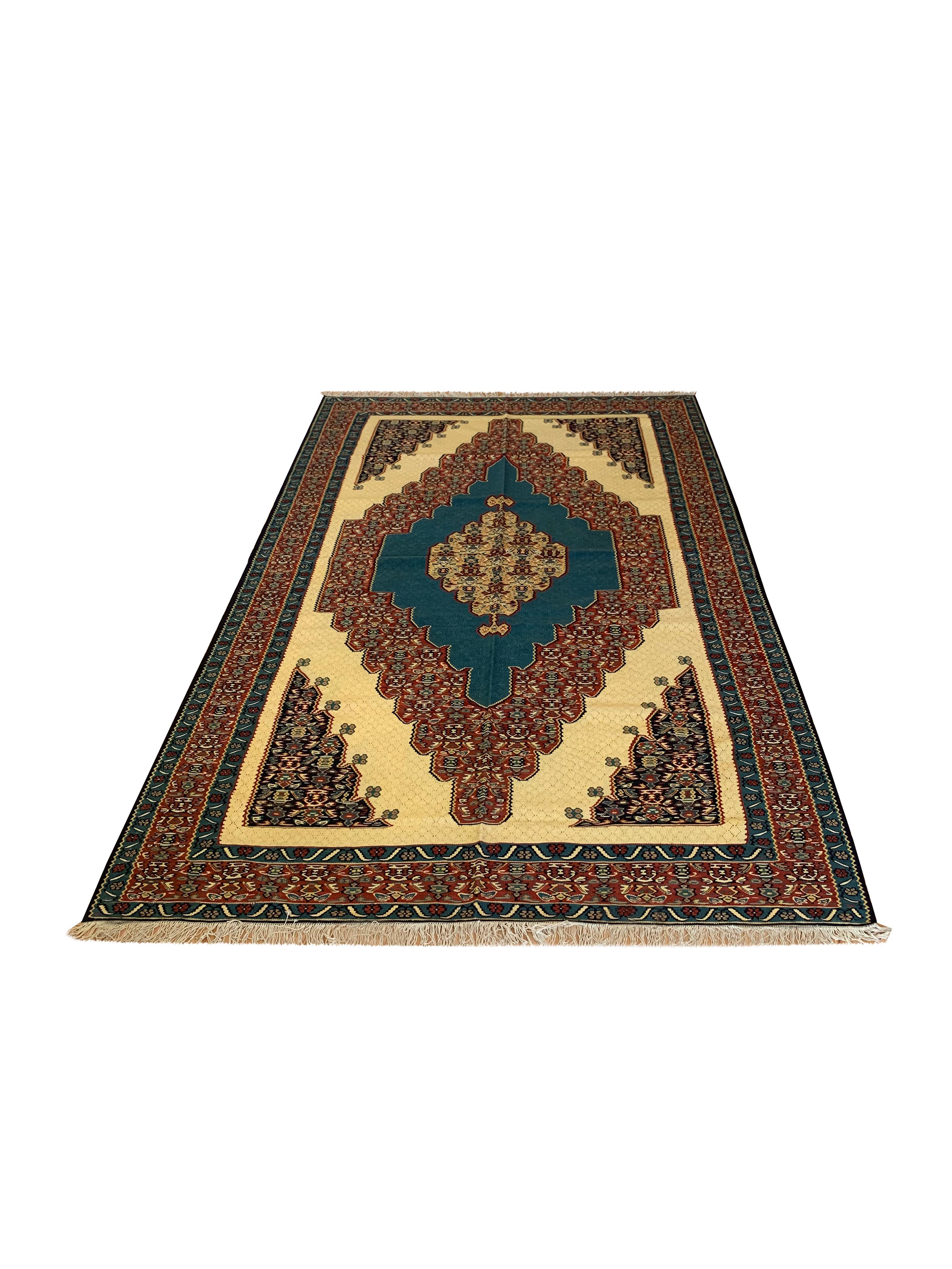 This beautiful wool carpet is a handmade, flatwoven kilim woven in the early 21st century, circa 2010. It is unused and so is in excellent condition. The design features a bold medallion design woven on a yellow background with blue, brown and cream