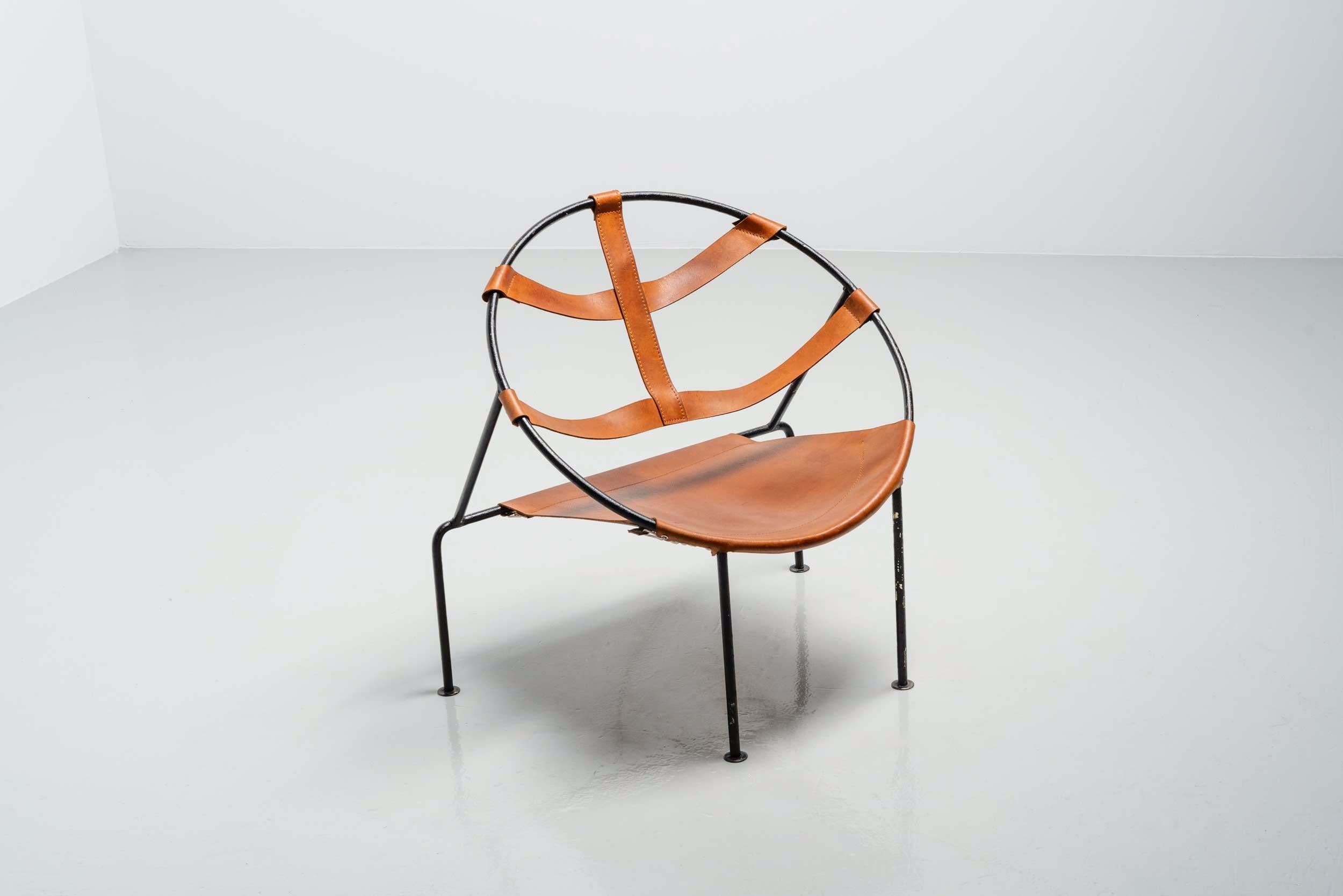 This chair model FDC-1 is designed by Flavio de Carvalho (1899-1973) and manufactured at a local atelier in Brazil, 1950. The chair has a solid steel sctructure, circle shaped and has a natural leater seat and back which has a stunning patina of