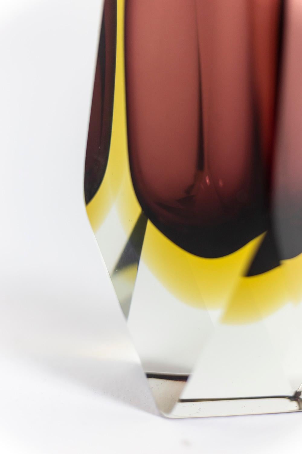 Flavio Poli, attributed to.
Luigi Mandruzzato, edited by. 

Murano vase in submerged glass with geometric facets, burgundy and yellow in color.

Italian work realized in the 1950s. 
 
 