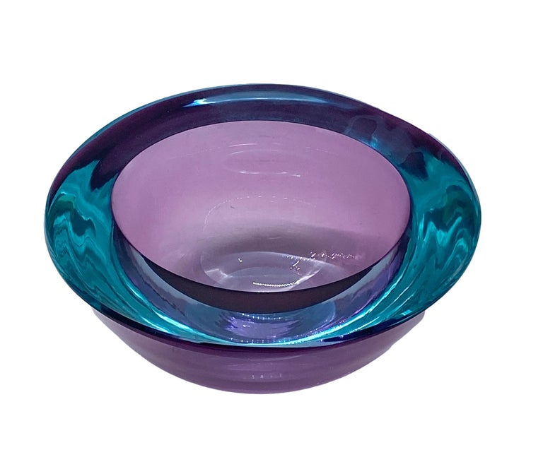 This heavy and thick decorative bowl is made of purple encased sommerso glass. 
It was designed by Flavio Poli in Murano, Italy, during the 1960s.